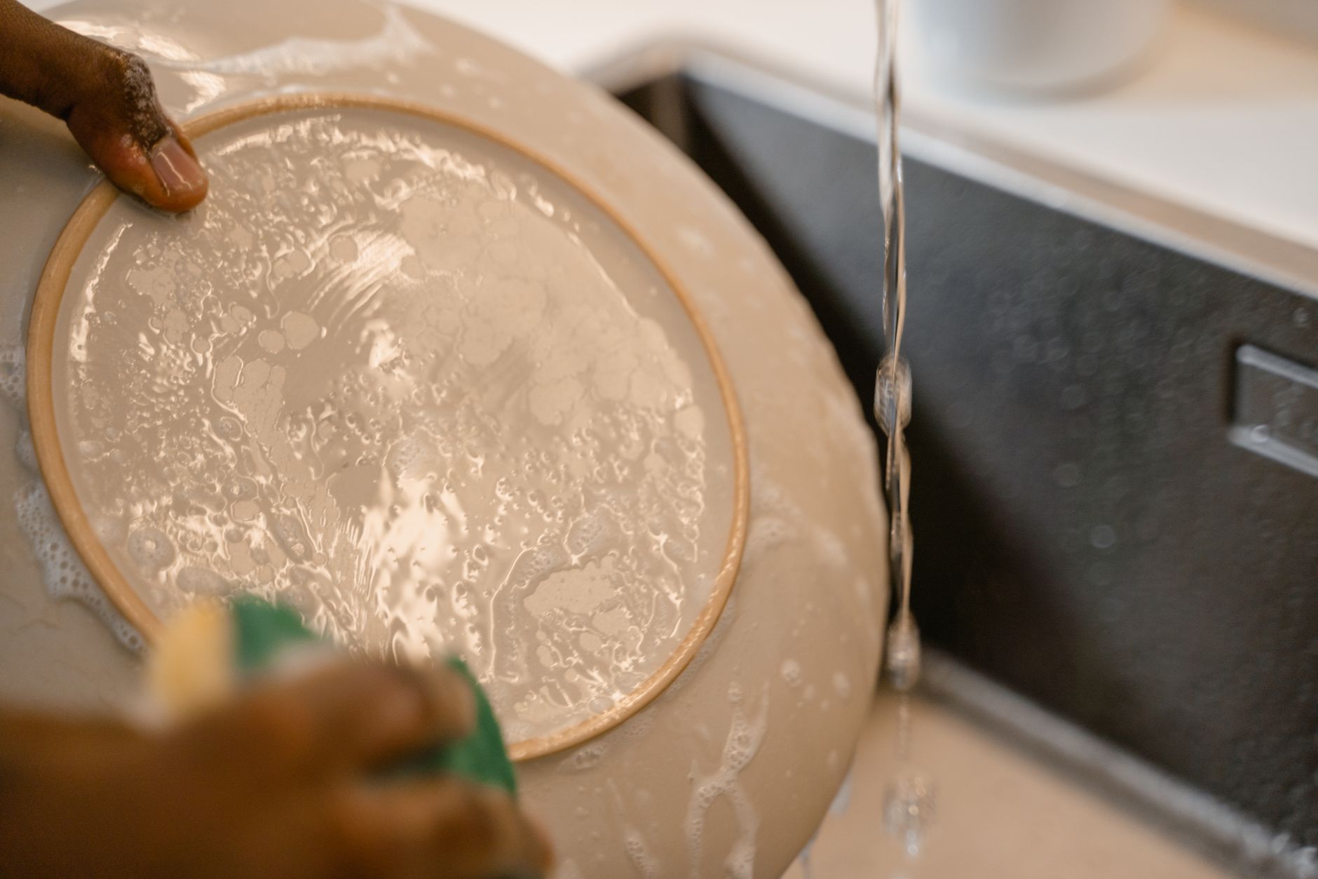 Washing a plate at a sink