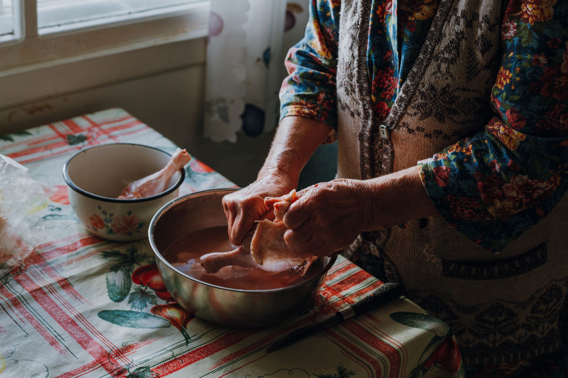 Preparing raw chicken in a bowl