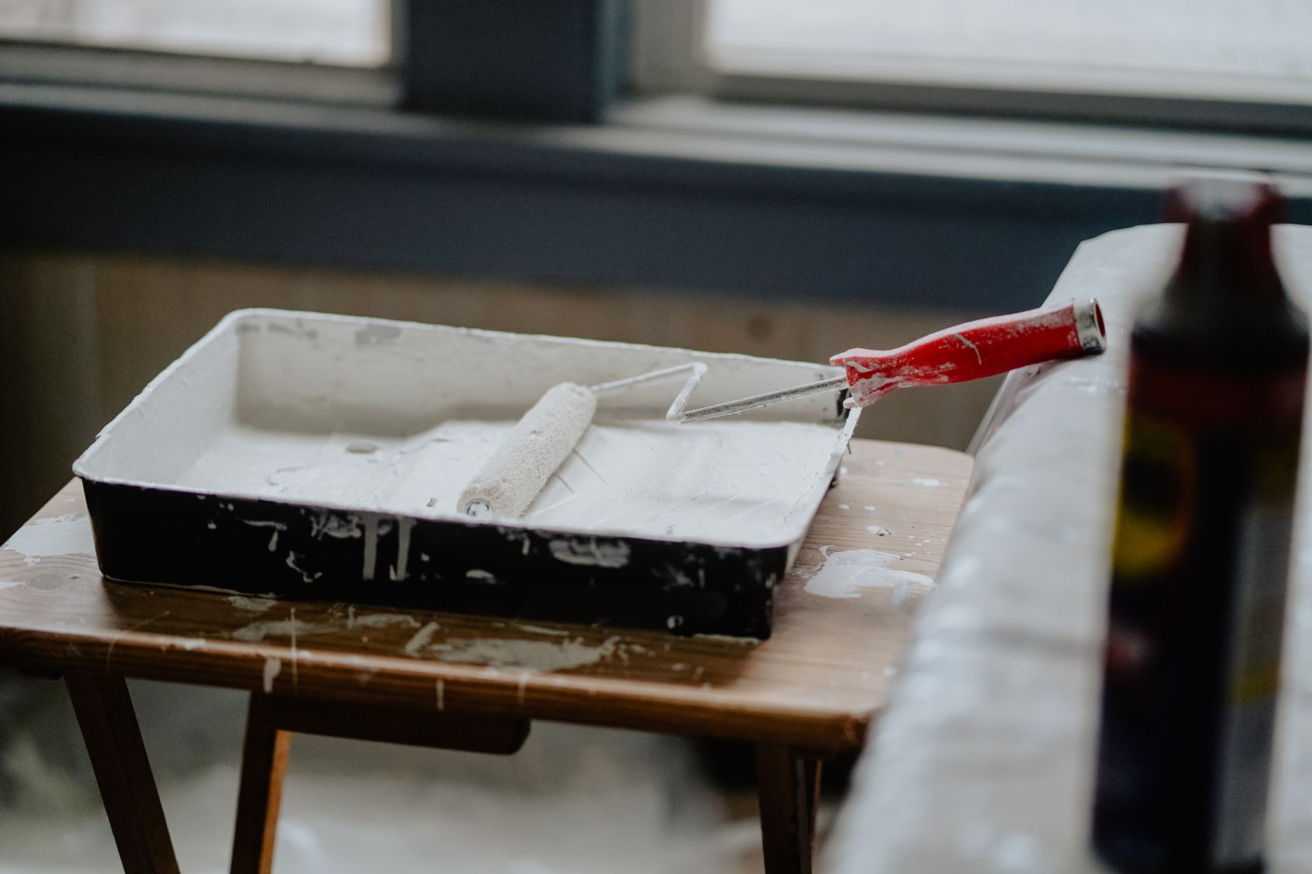 A paint tray and roller on a table