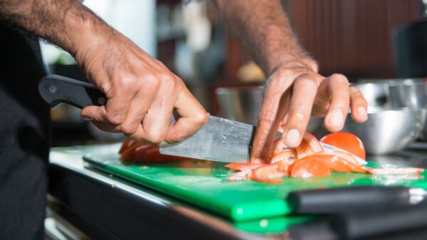 Best knife sharpener: a chef’s knife on a wooden cutting board