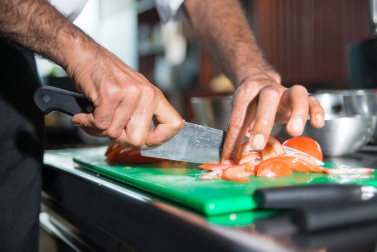 Best knife sharpener: a chef’s knife on a wooden cutting board