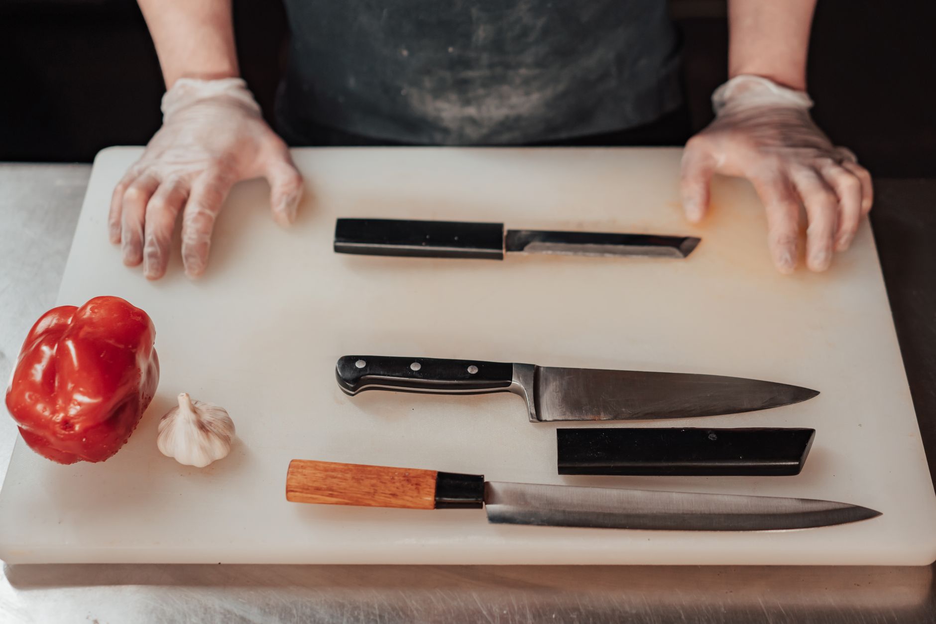 Kitchen knives on a white cutting board