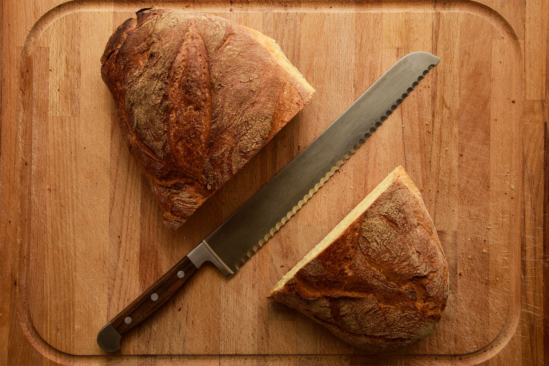 A bread knife and a sliced loaf