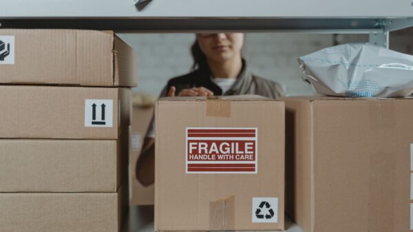 A person packing boxes on a shelf