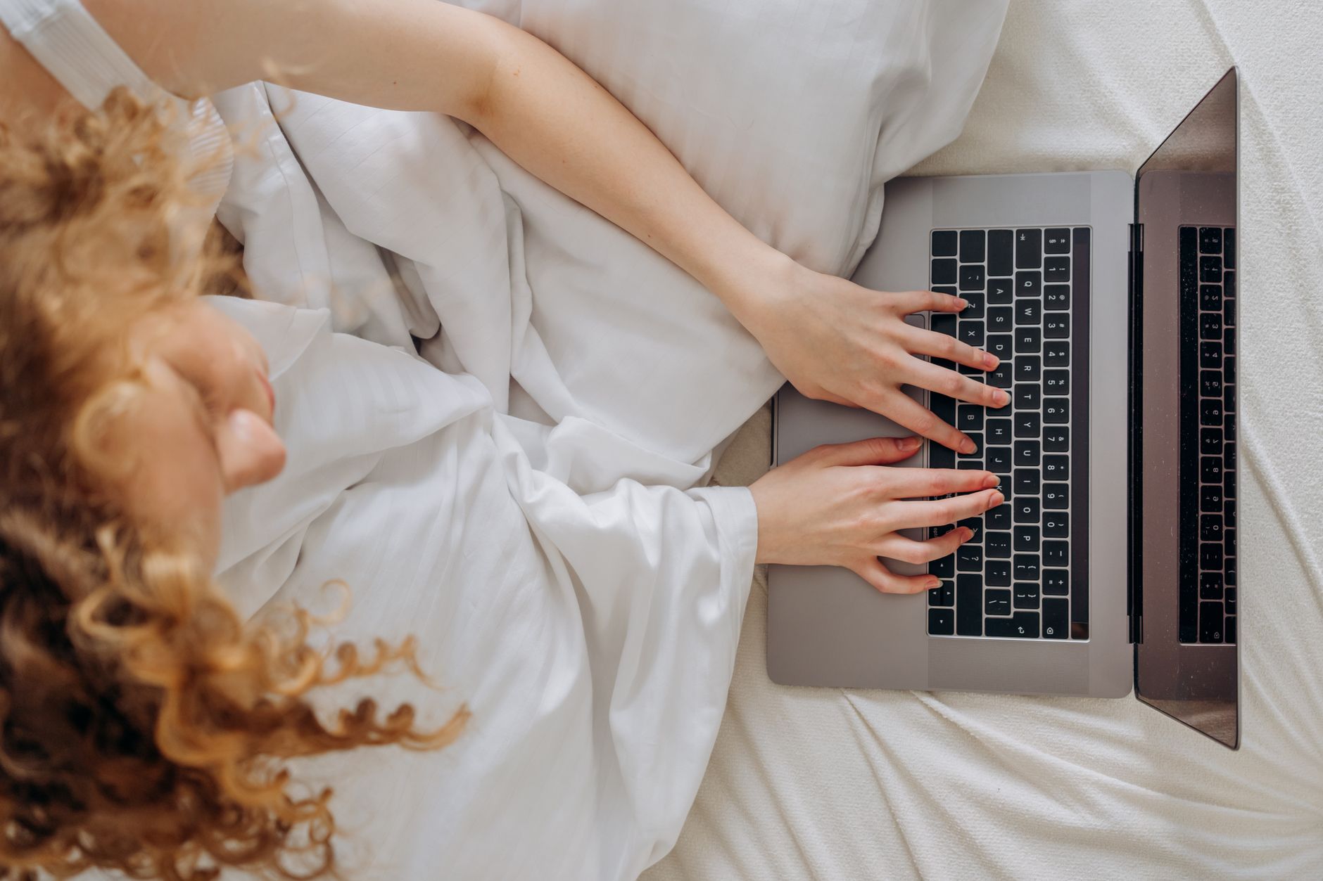Working on a laptop in bed