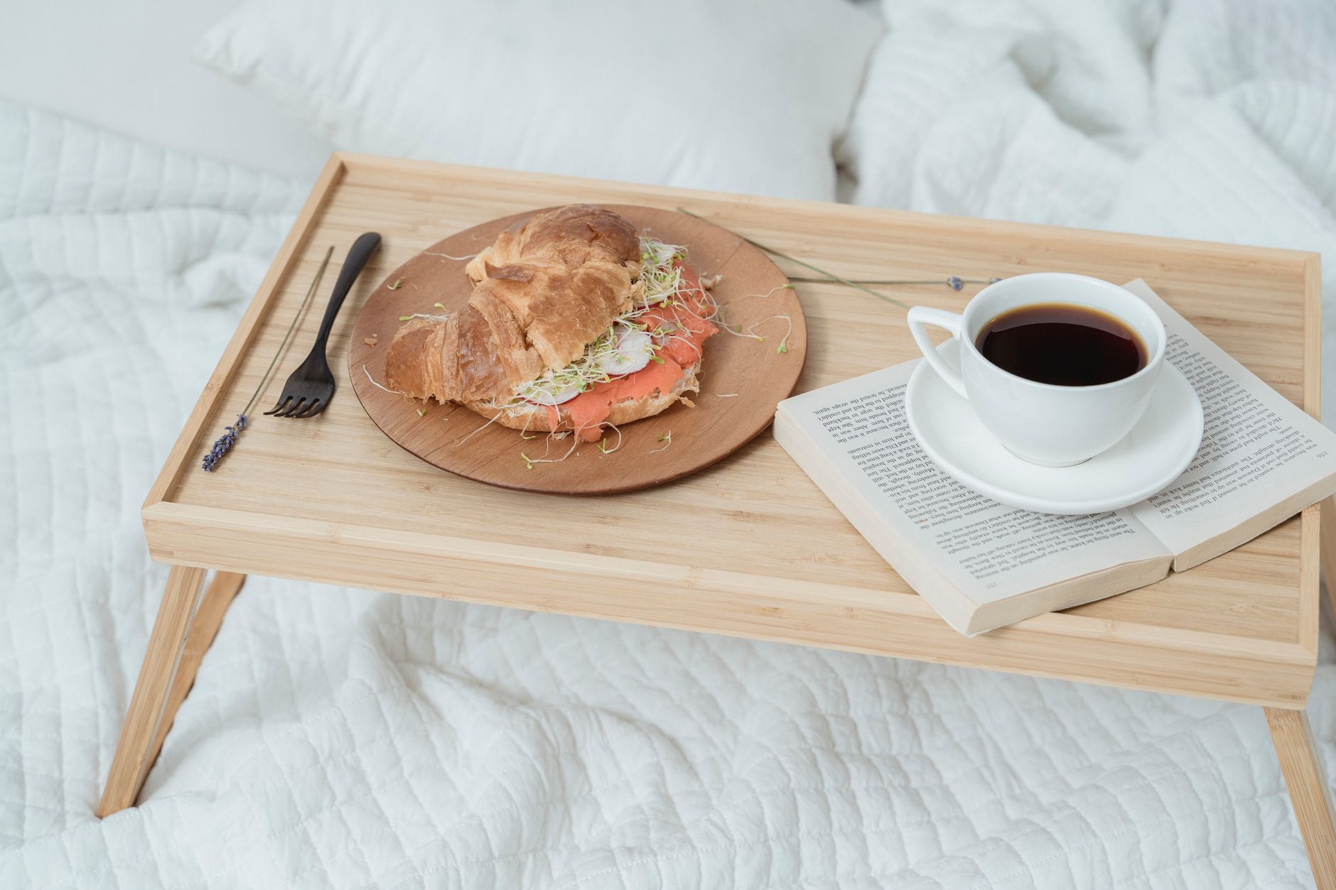 A tray with breakfast set on a bed