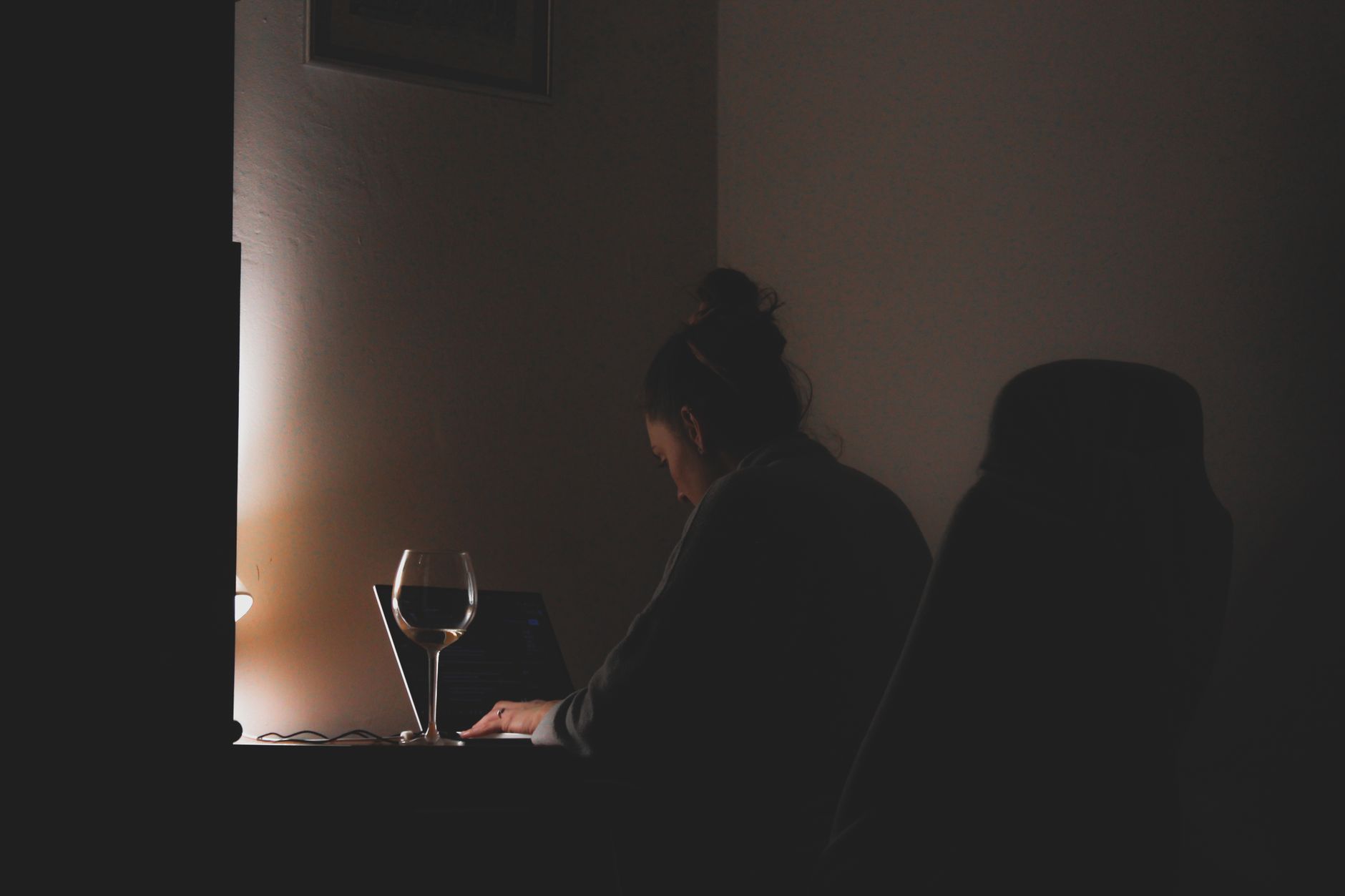 A laptop open on a work surface in the evening