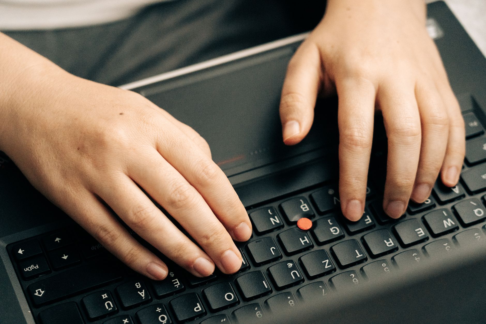 Hands typing on a separate keyboard