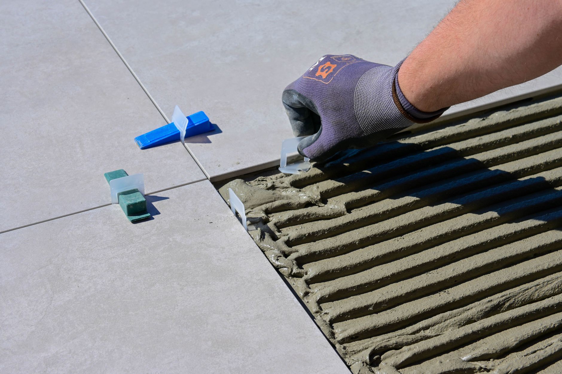 Floor tiles being laid in a room