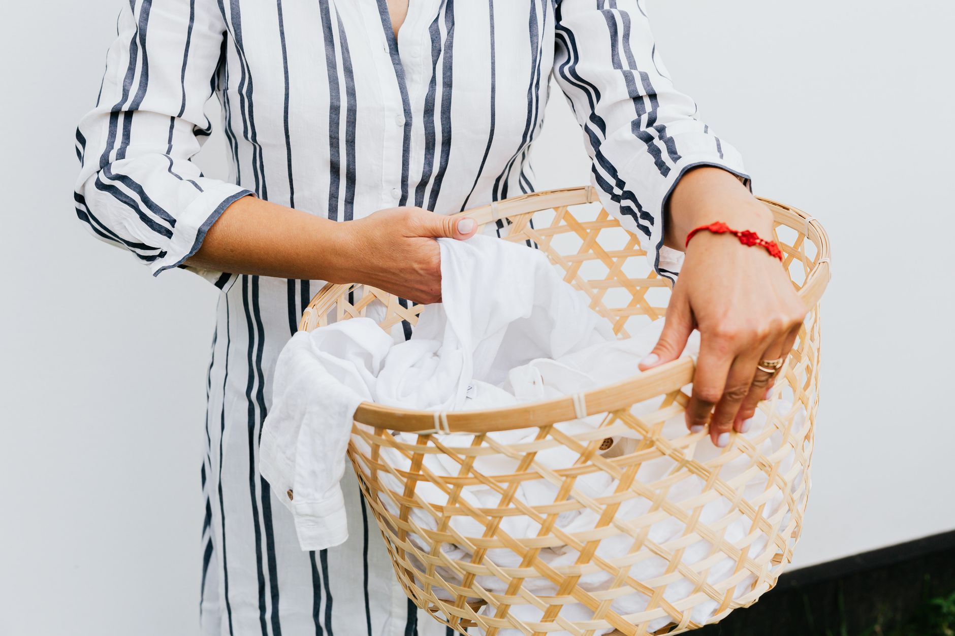 Carrying a basket of white laundry