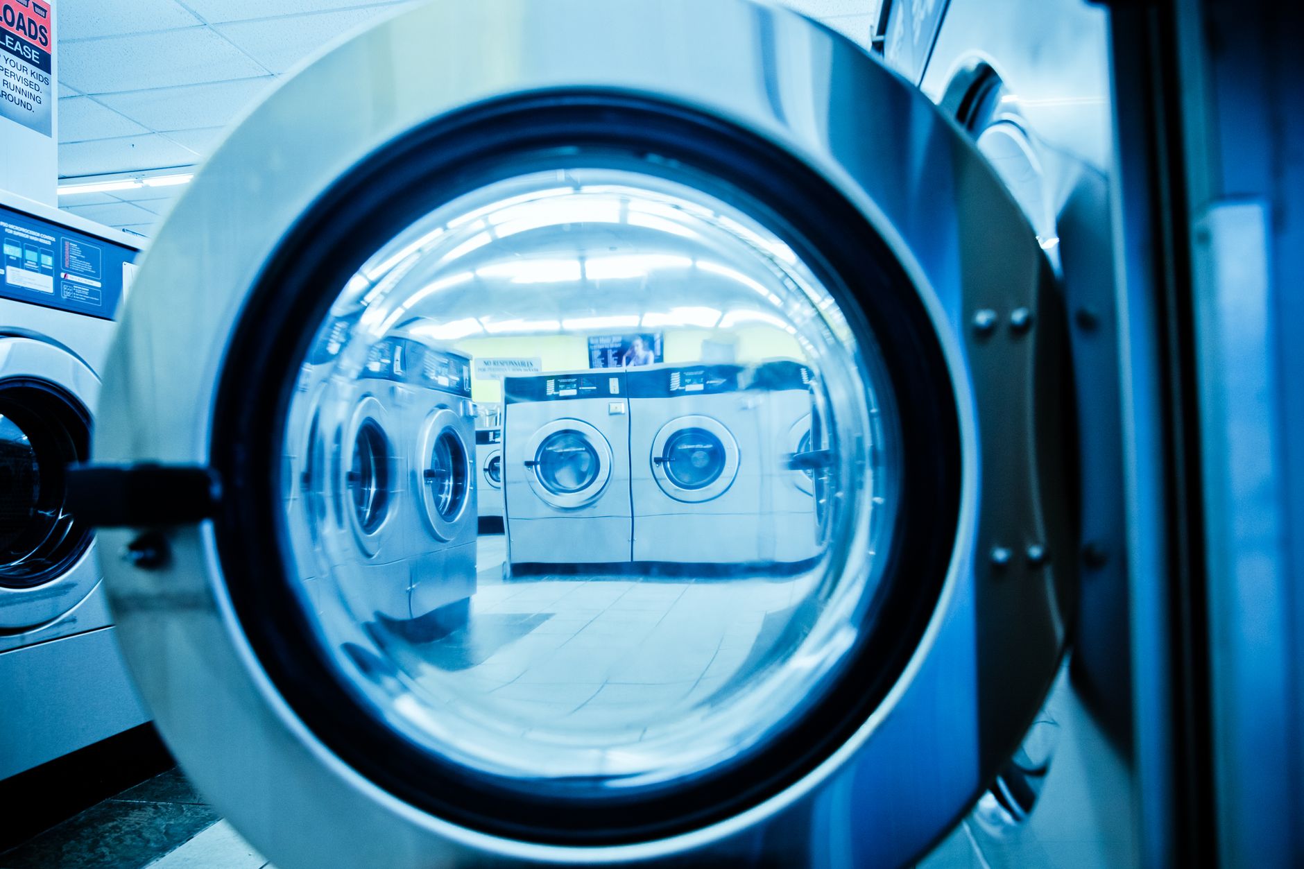 Looking through a washer door in a laundromat