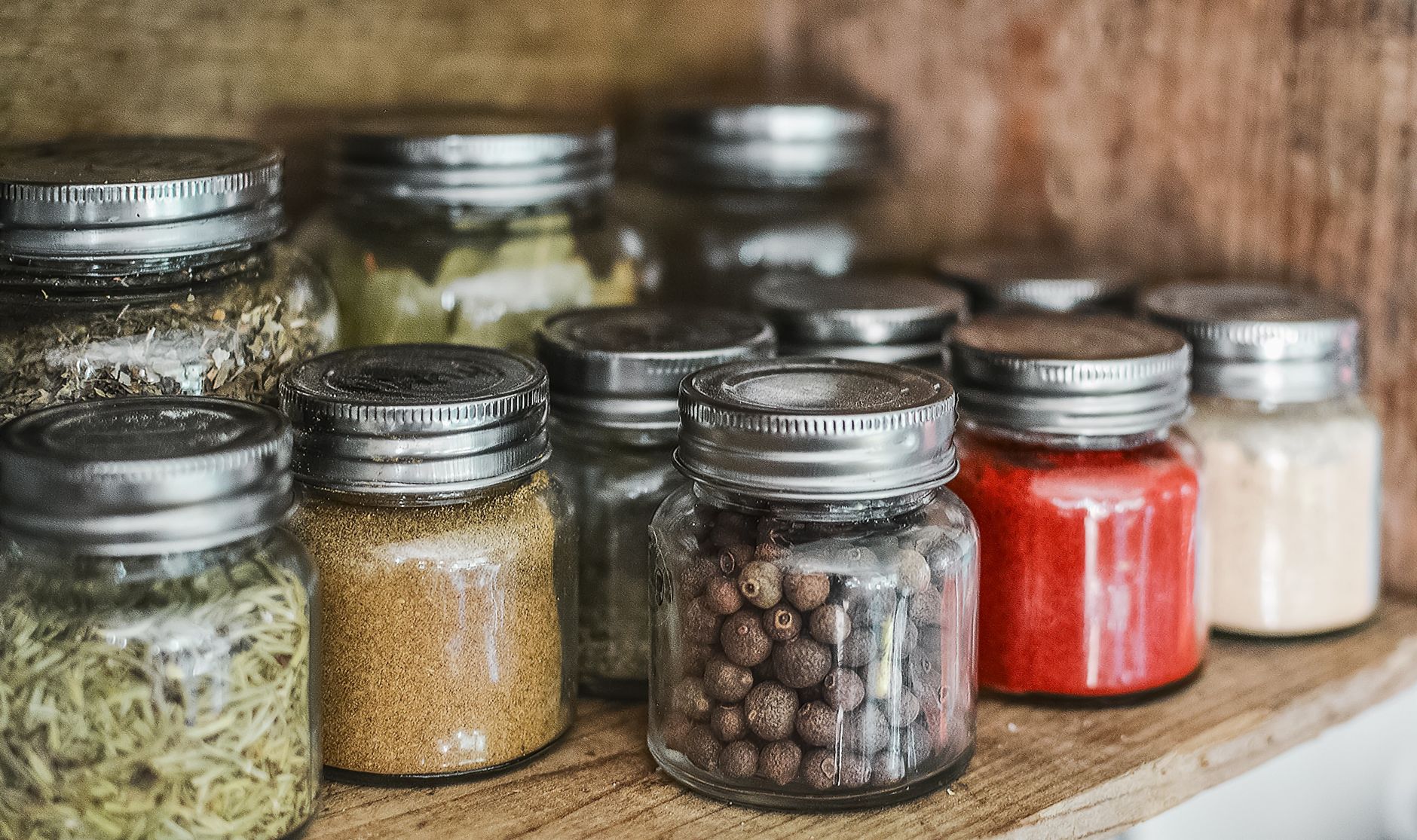 Glass jars of spices with metal lids