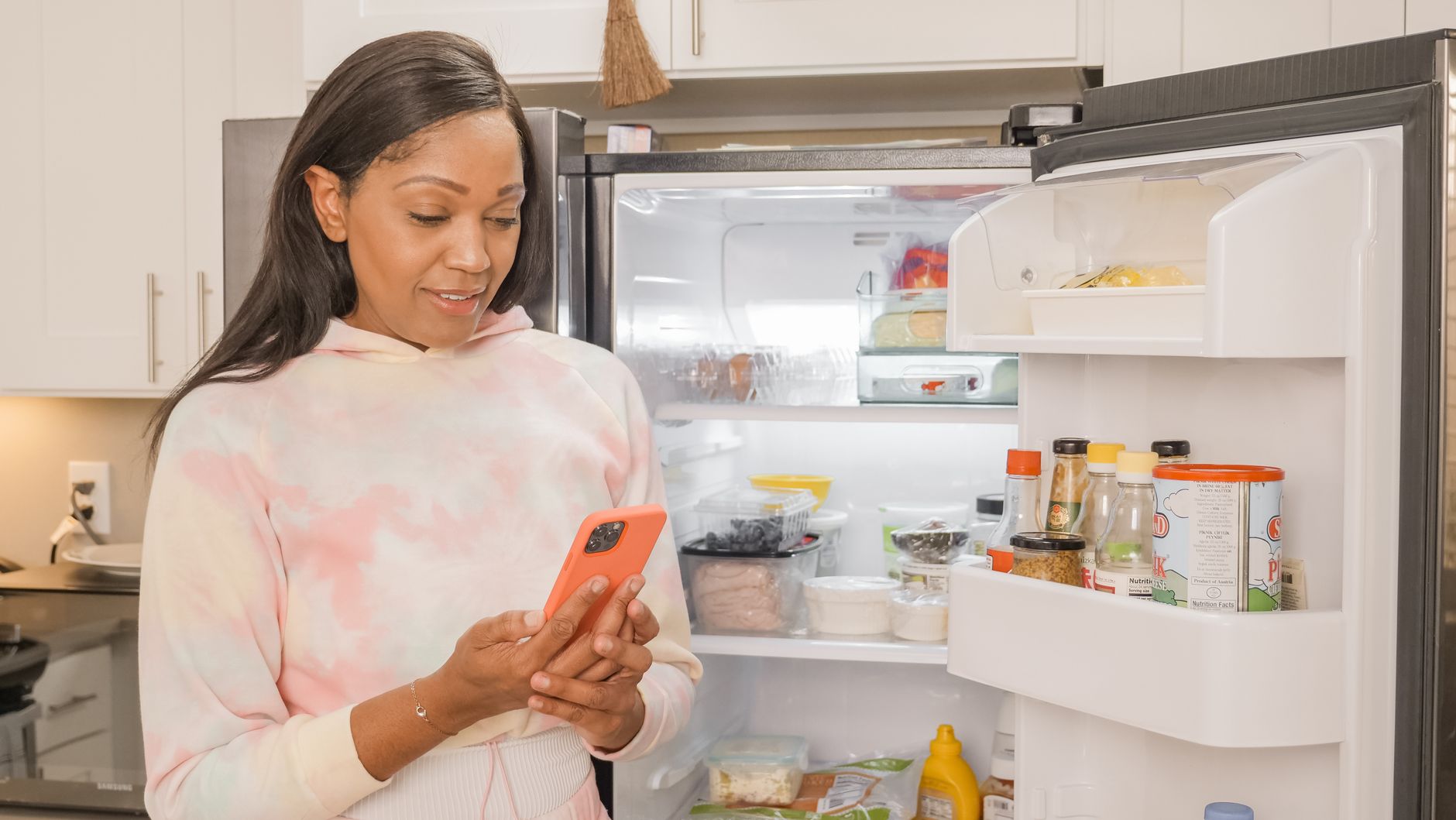 A woman looking into an open refrigerator