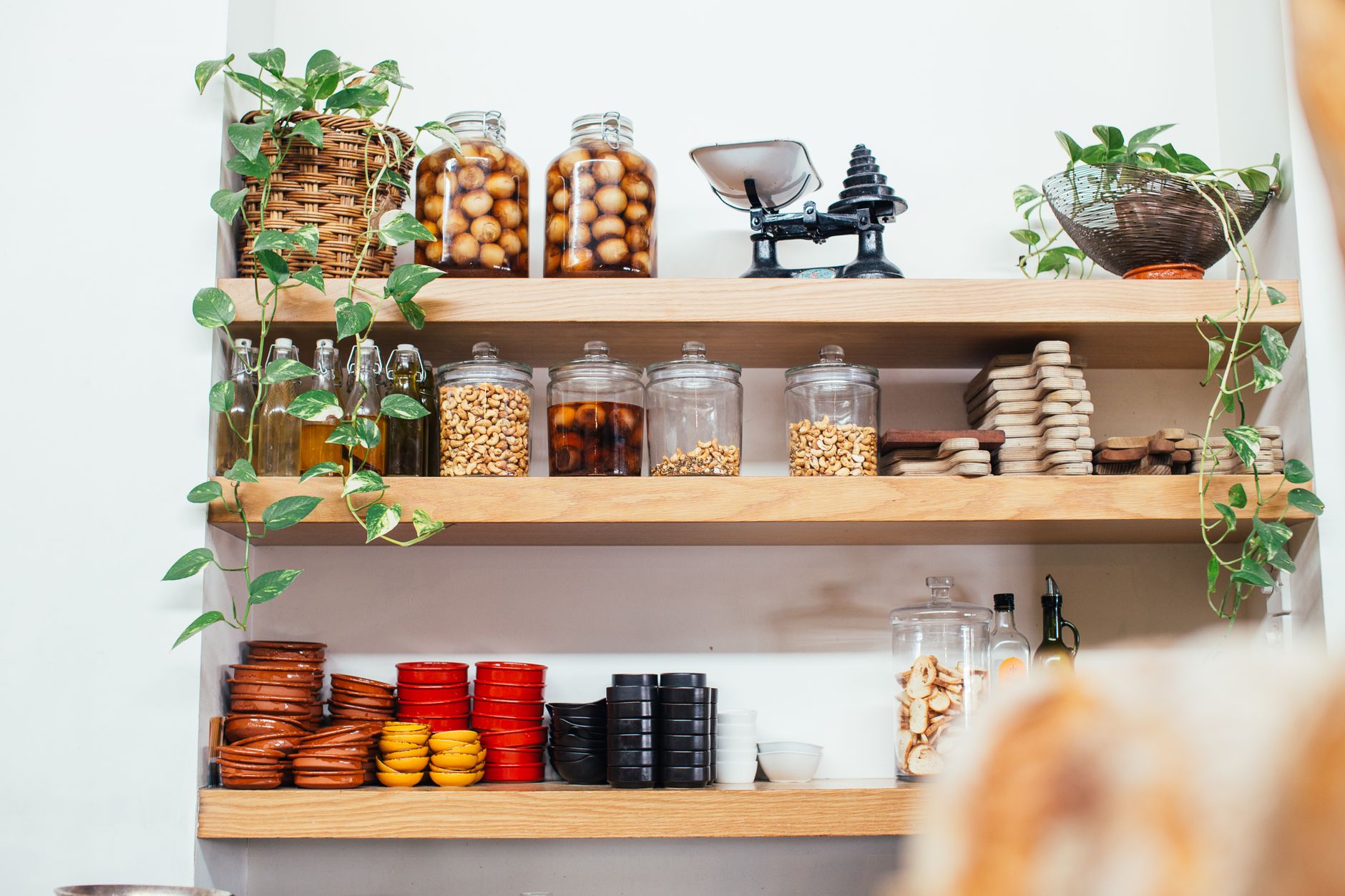Open wall shelves holding jars and dishes