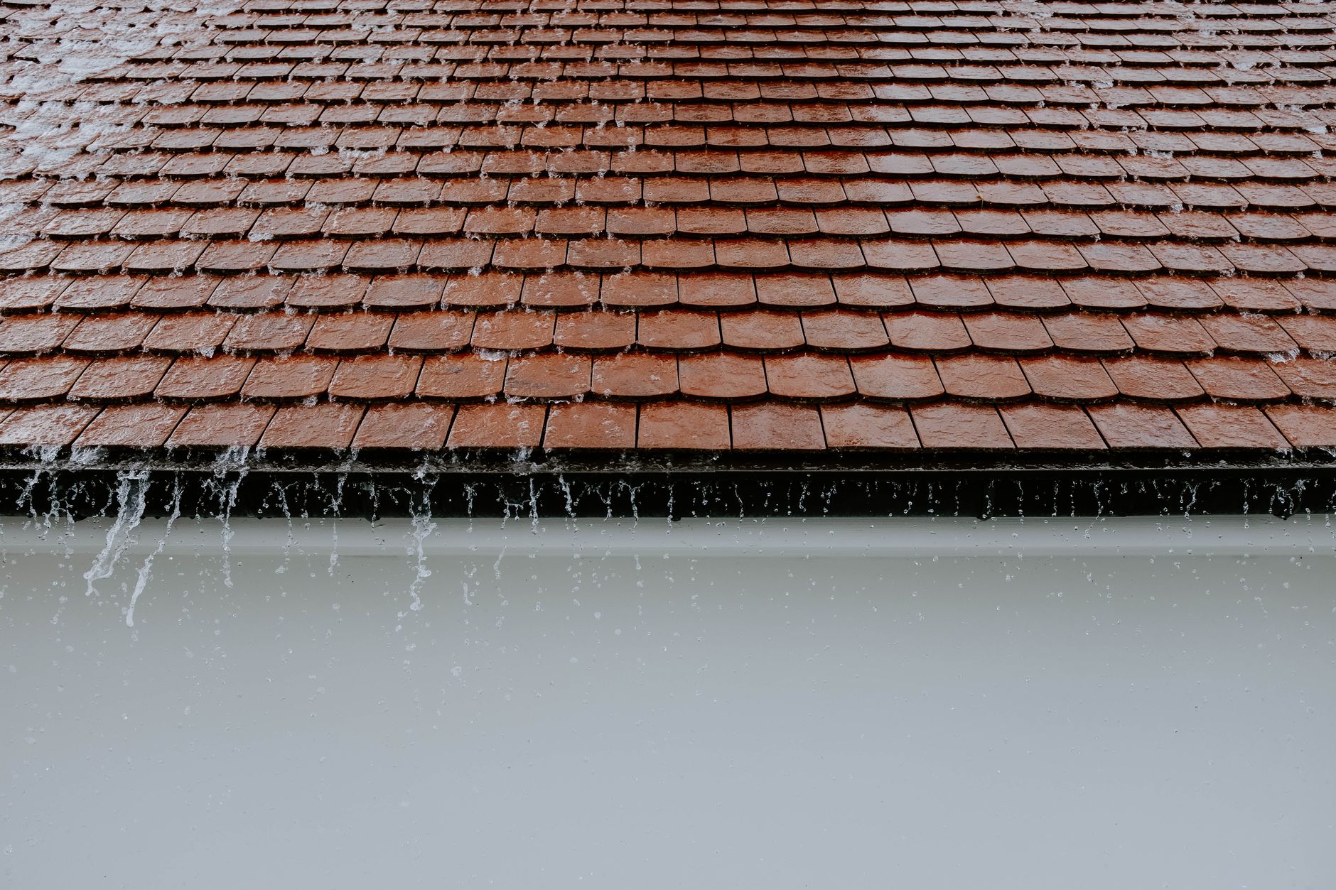 Rain running off a tiled roof