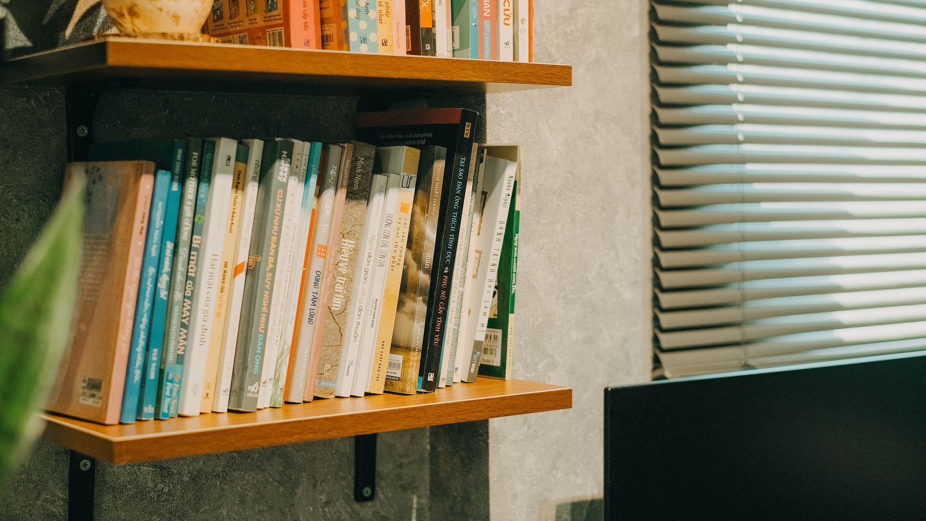 A wall shelf holding books and decor