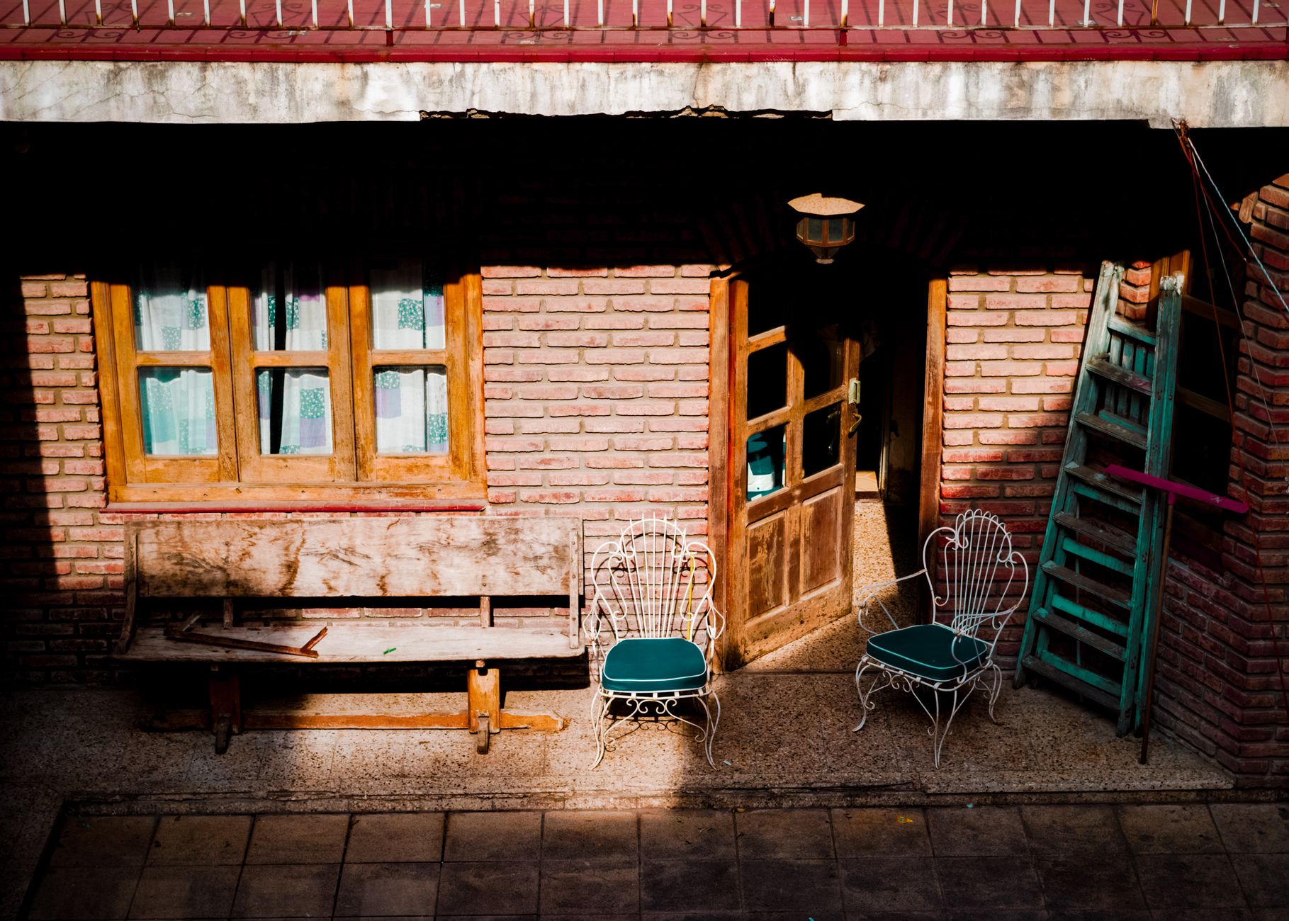 A ladder against a brick house