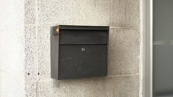 A black wall-mounted mailbox