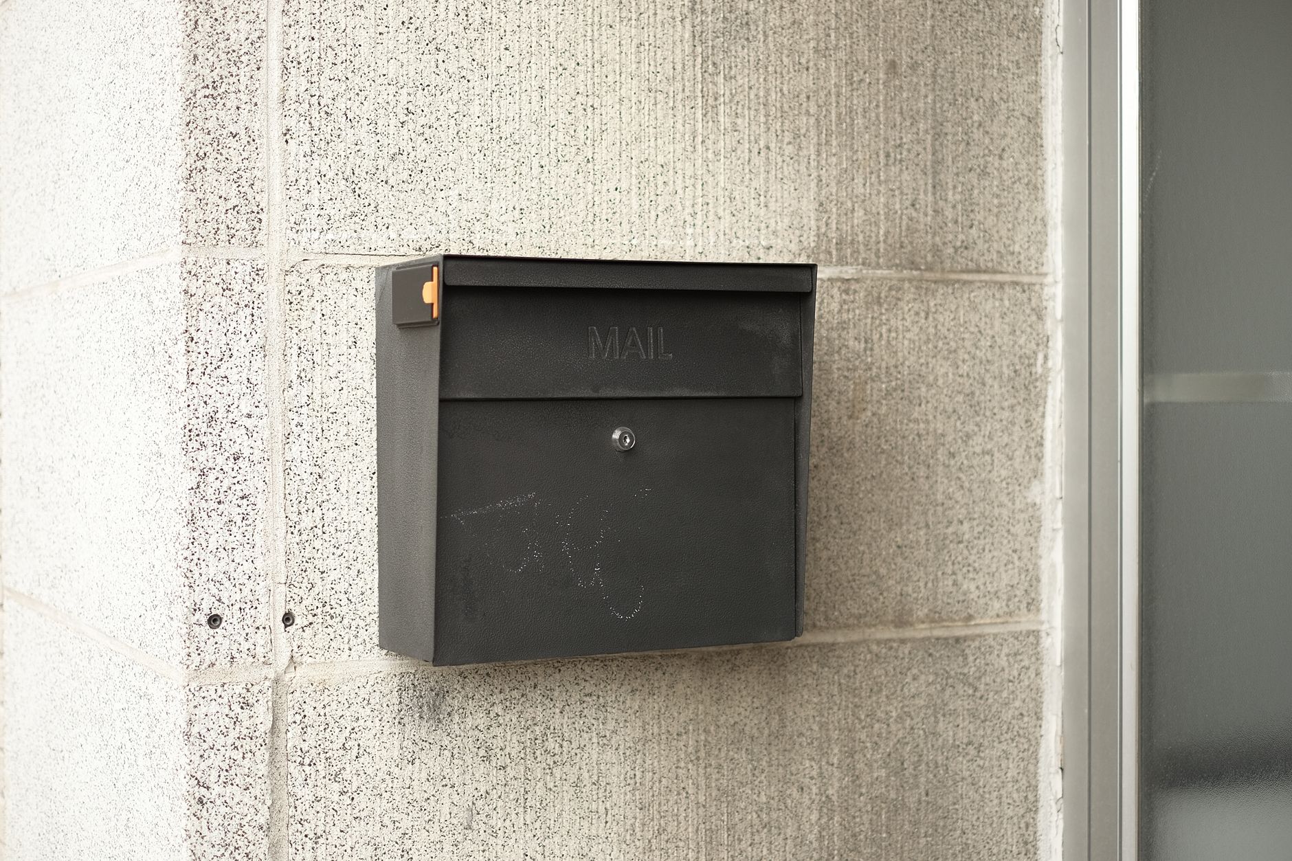 A black wall-mounted mailbox