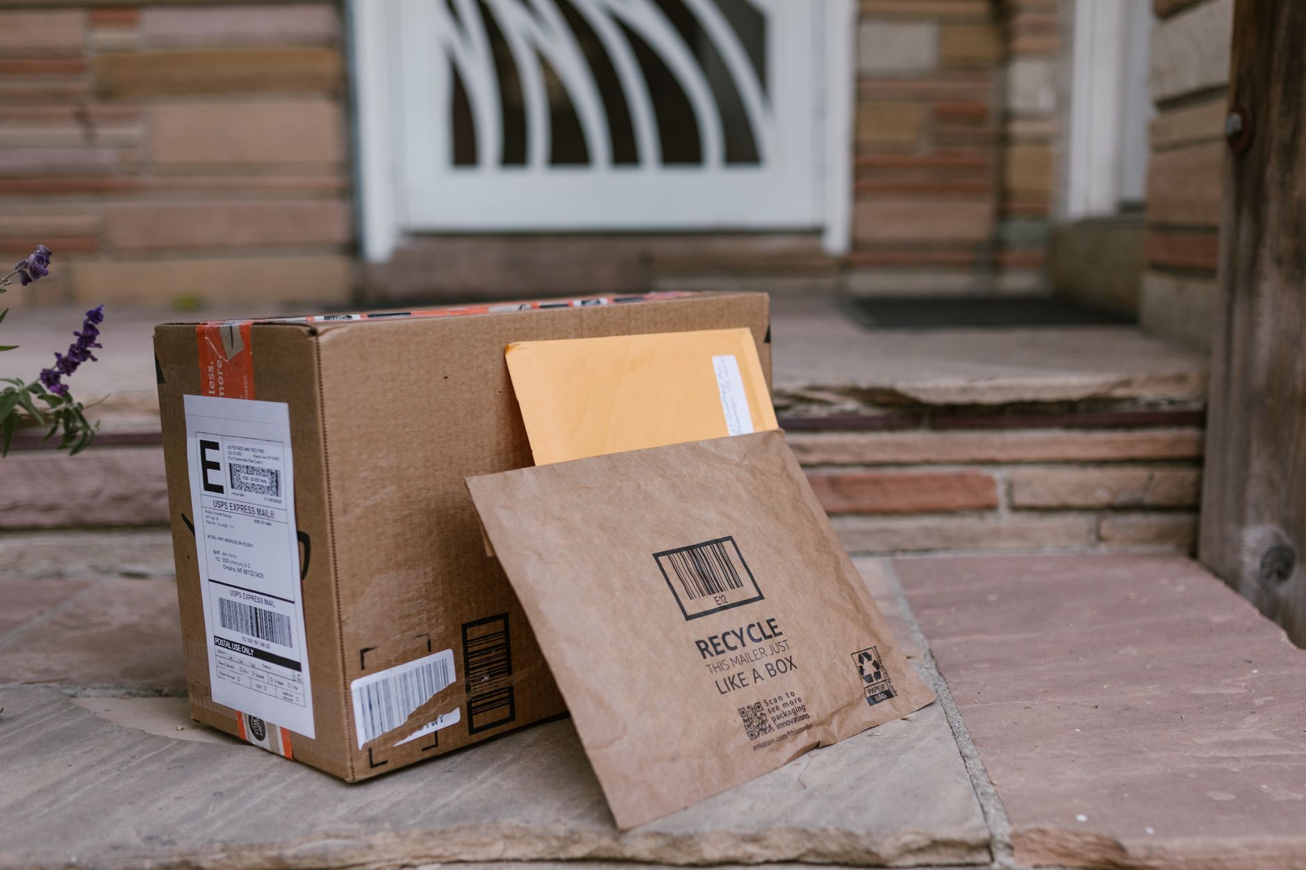 A package and envelopes left on a front step