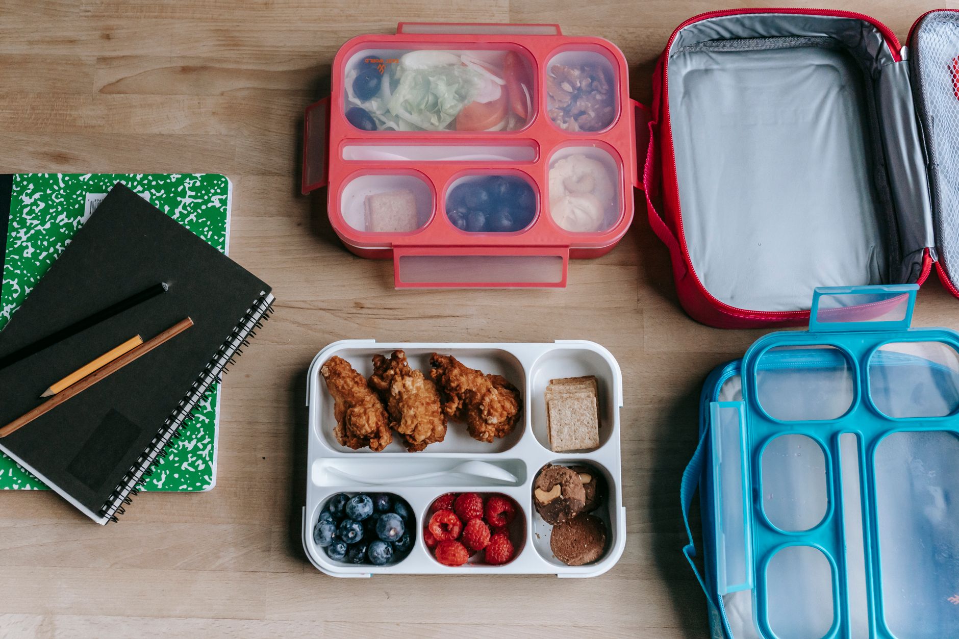 Packed bento boxes and lunch bags on a table
