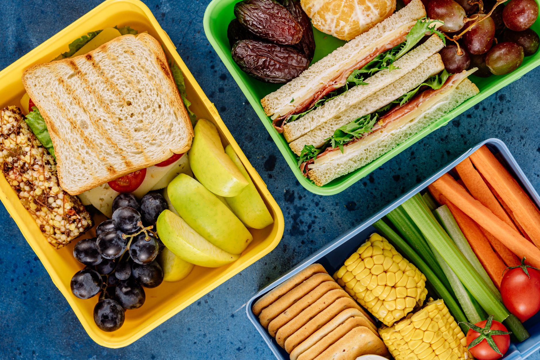 Sandwiches and fruit in colorful containers