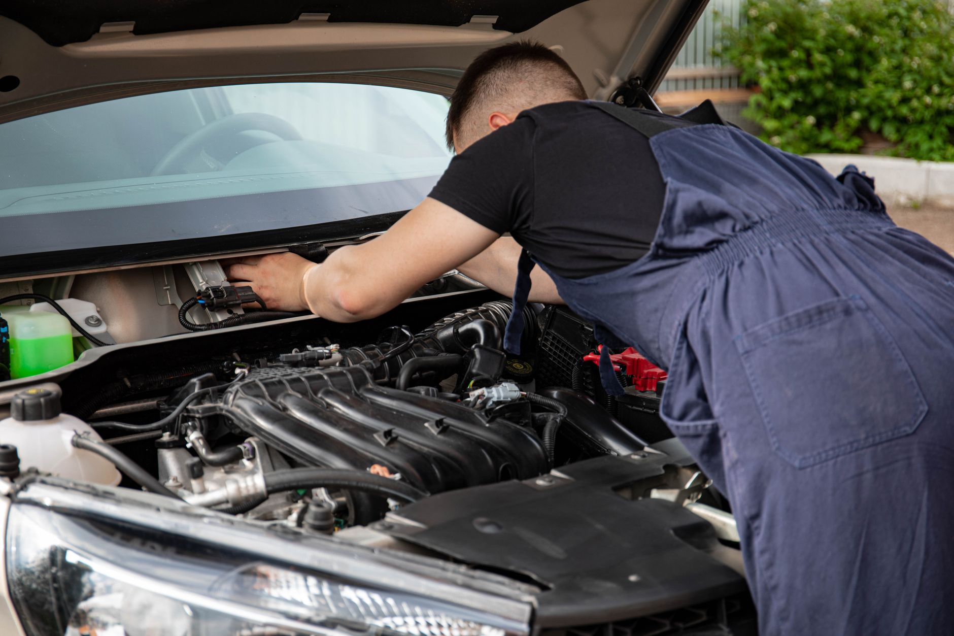 Hands working on a car engine