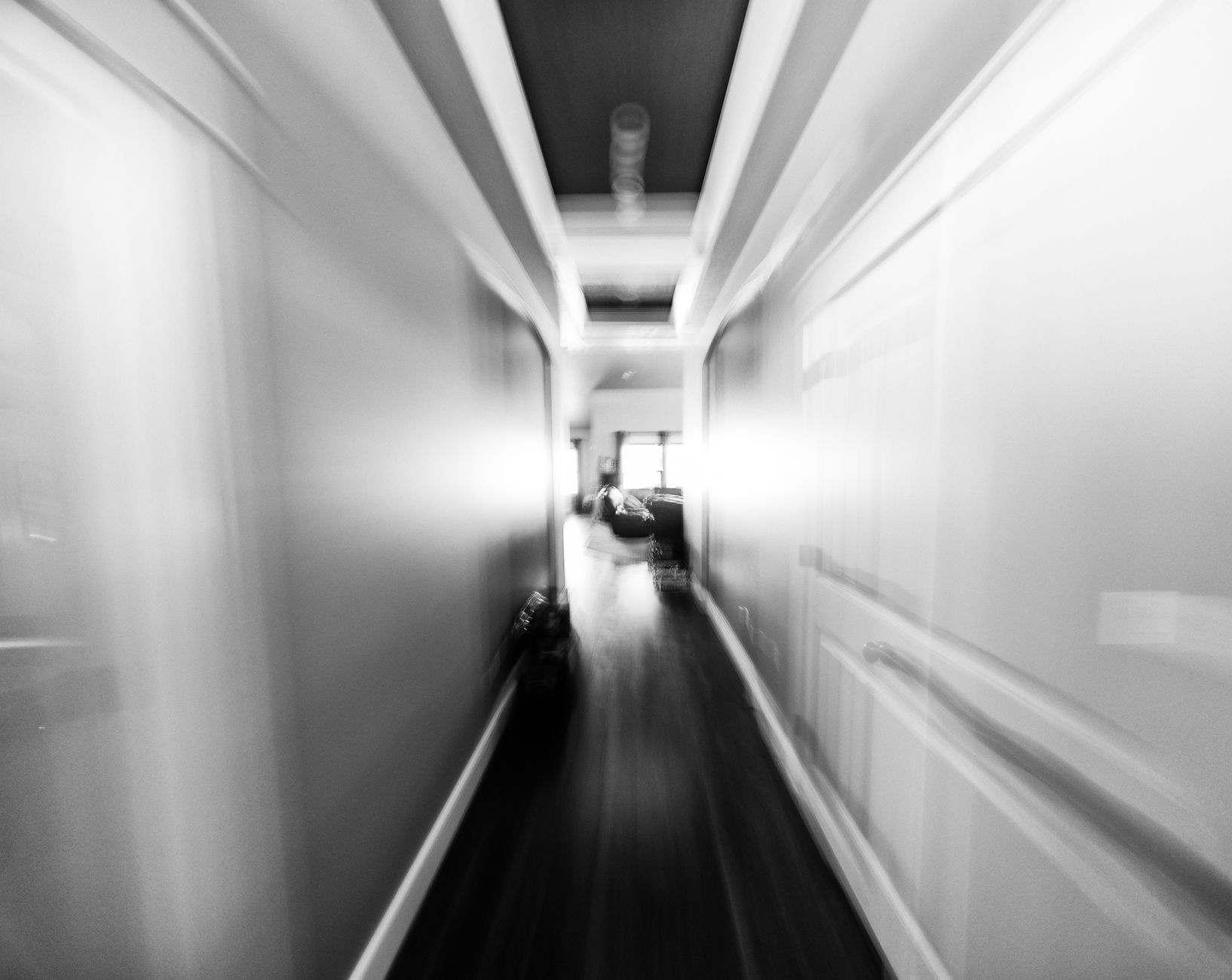 A long hallway in black and white