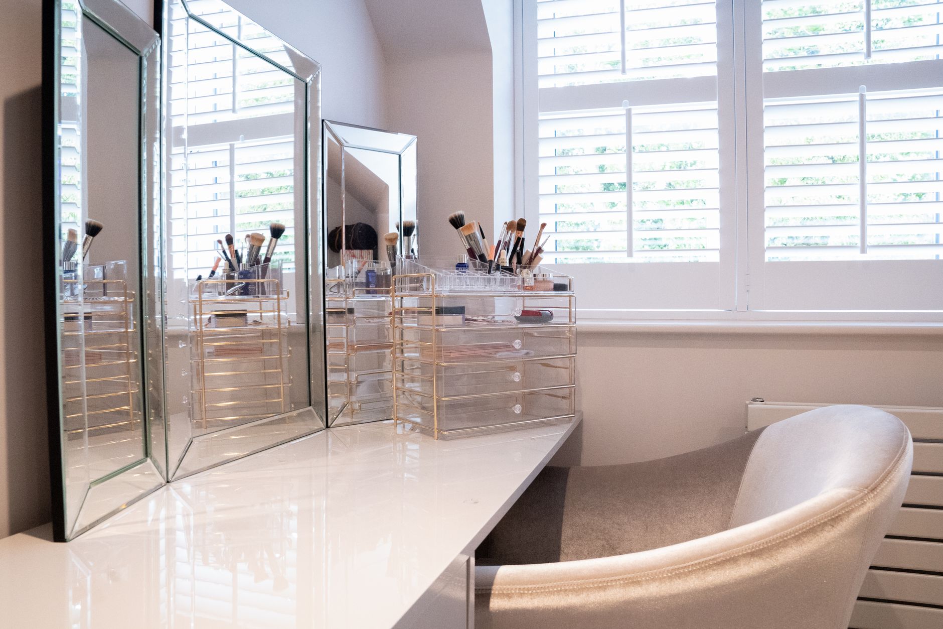 Best makeup organizer: makeup and brushes arranged on a vanity table