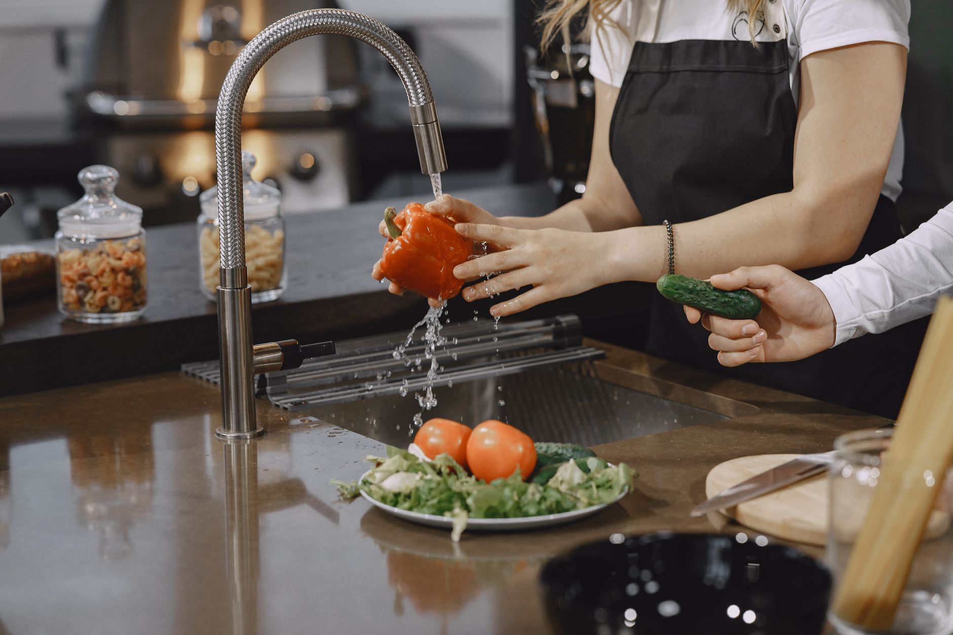 Rinsing vegetables at a kitchen sink