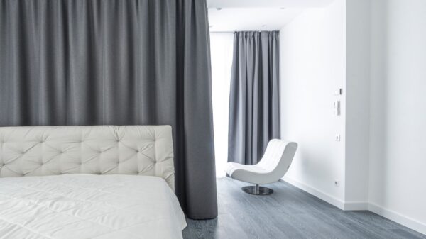 A white bed in a minimalist bedroom