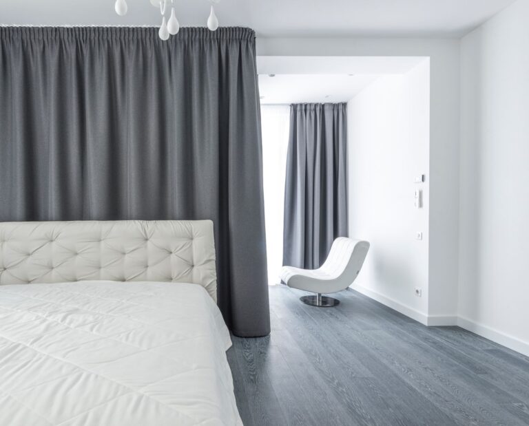 Best mattress protector: a neatly made bed with white bedding