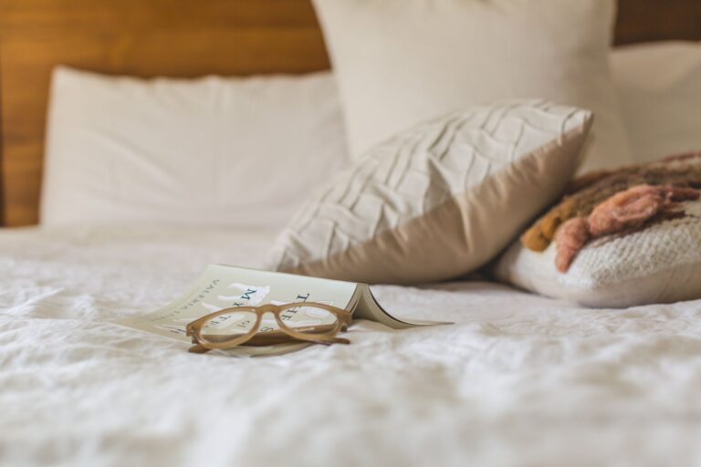 Best mattress topper: glasses and a book on a soft bed
