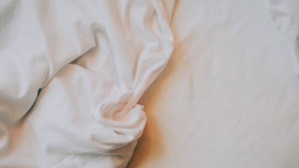 Best mattress vacuum: rumpled white bed sheets
