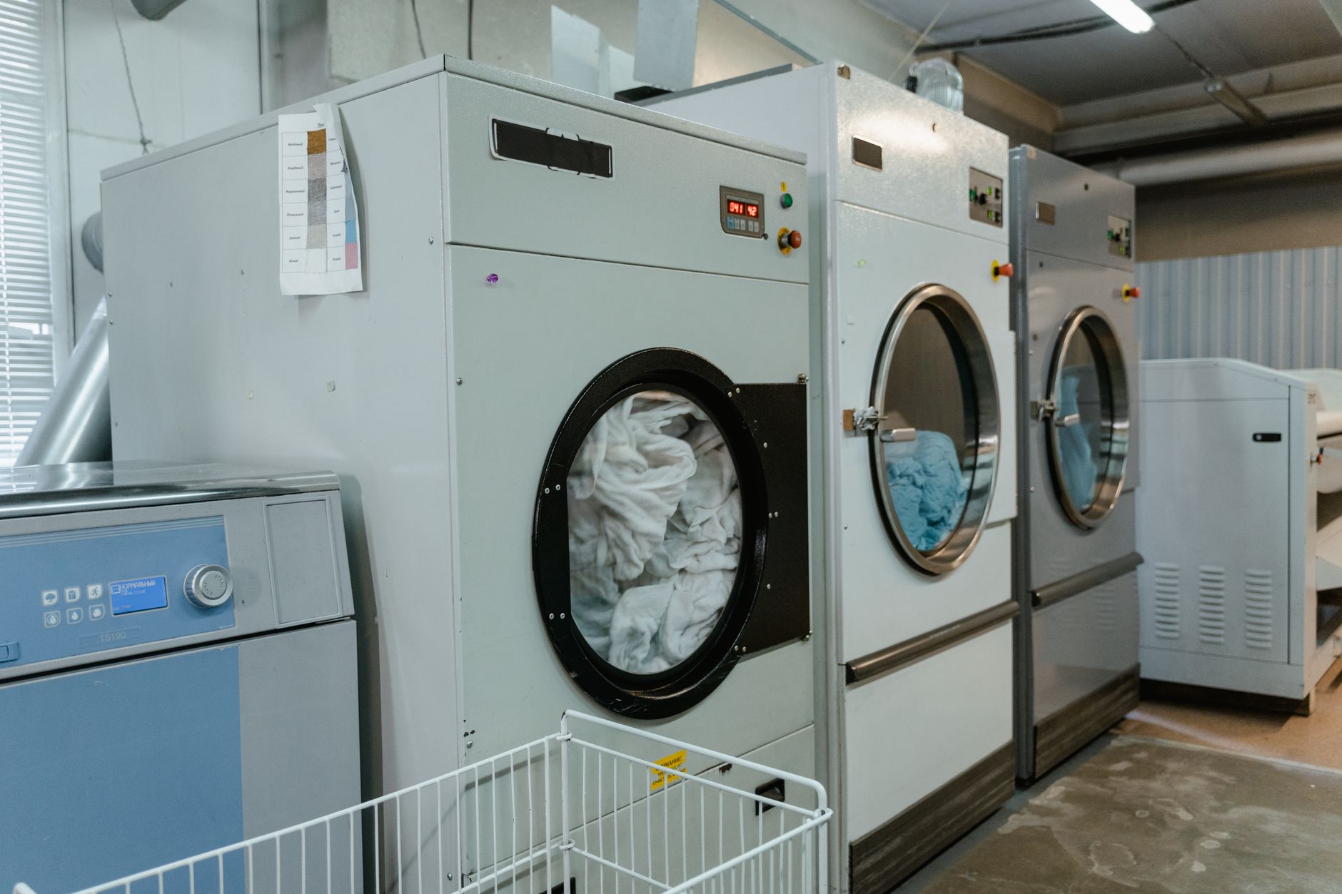 Commercial washers and dryers in a laundry