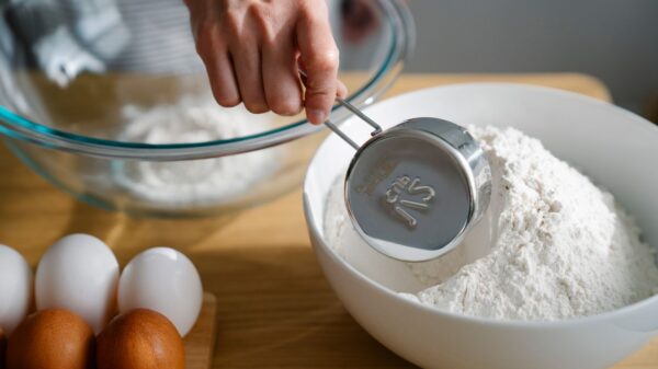 Scooping flour with a measuring cup