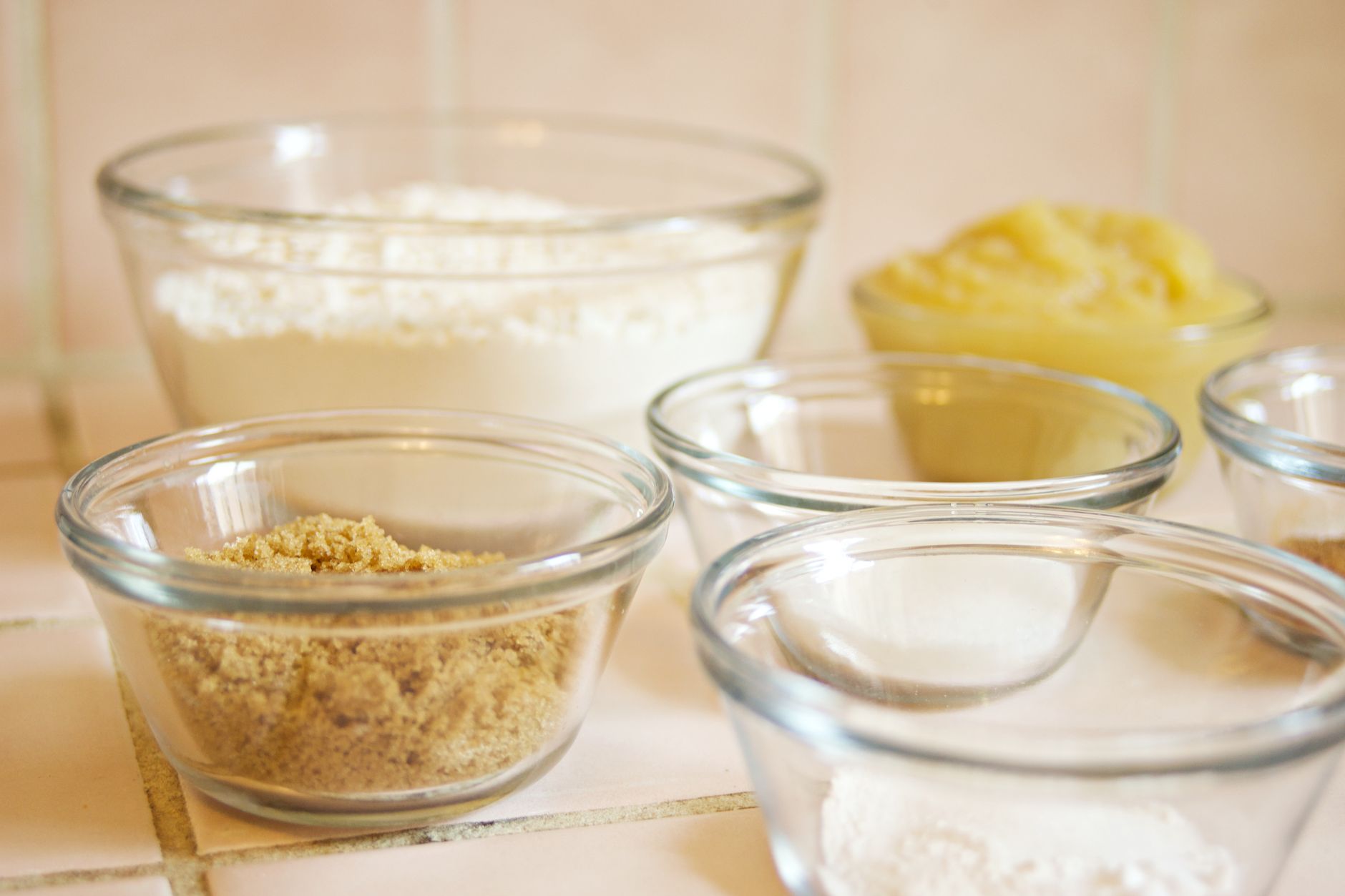 Glass bowls of measured baking ingredients