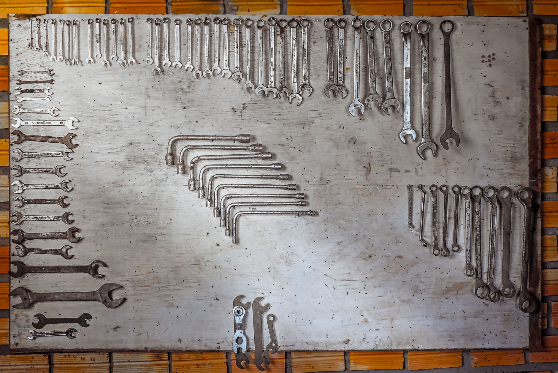 Wrenches arranged on a metal wall board