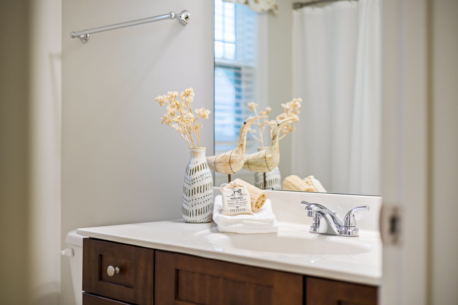 A tidy bathroom with a vanity and mirror