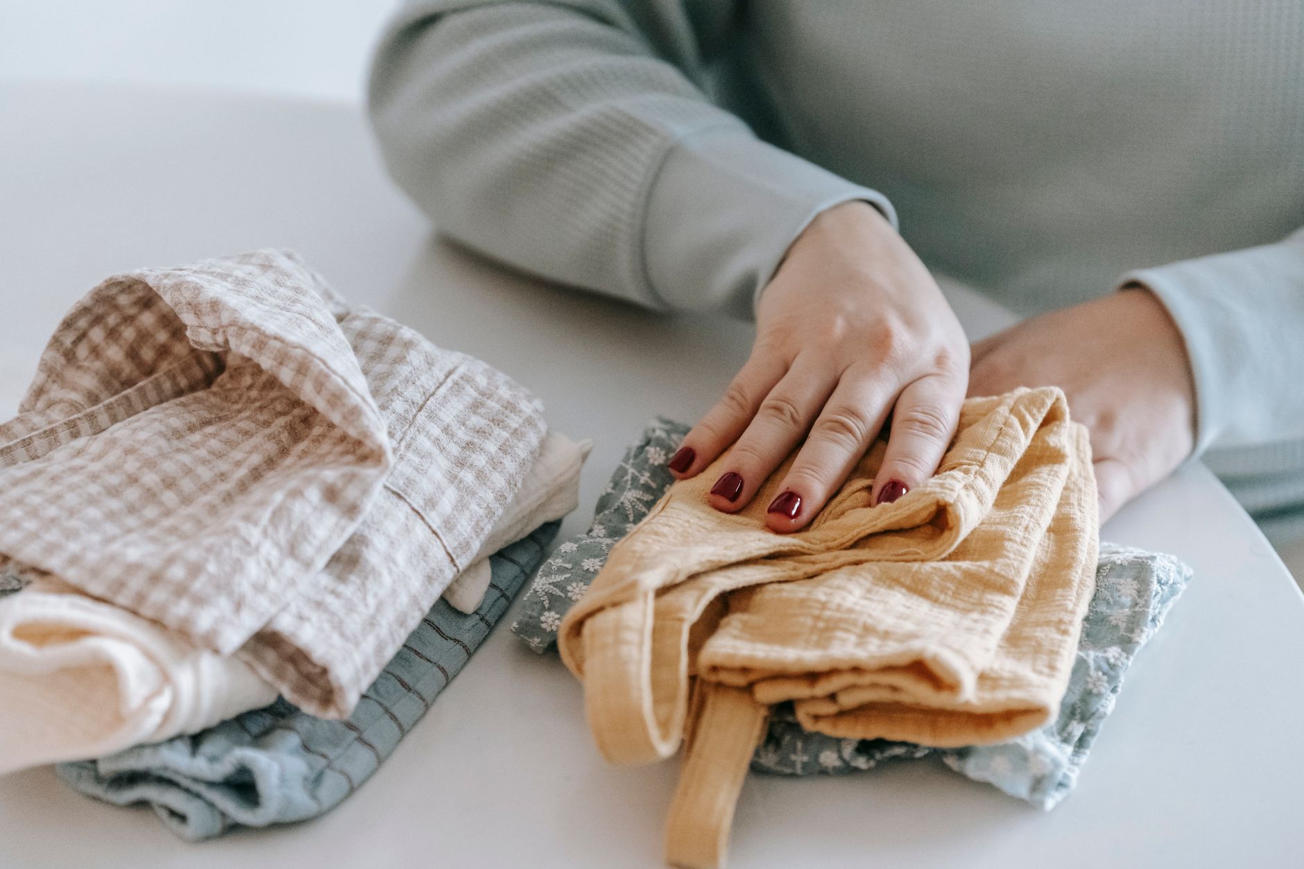 Folding kitchen cloths on a table