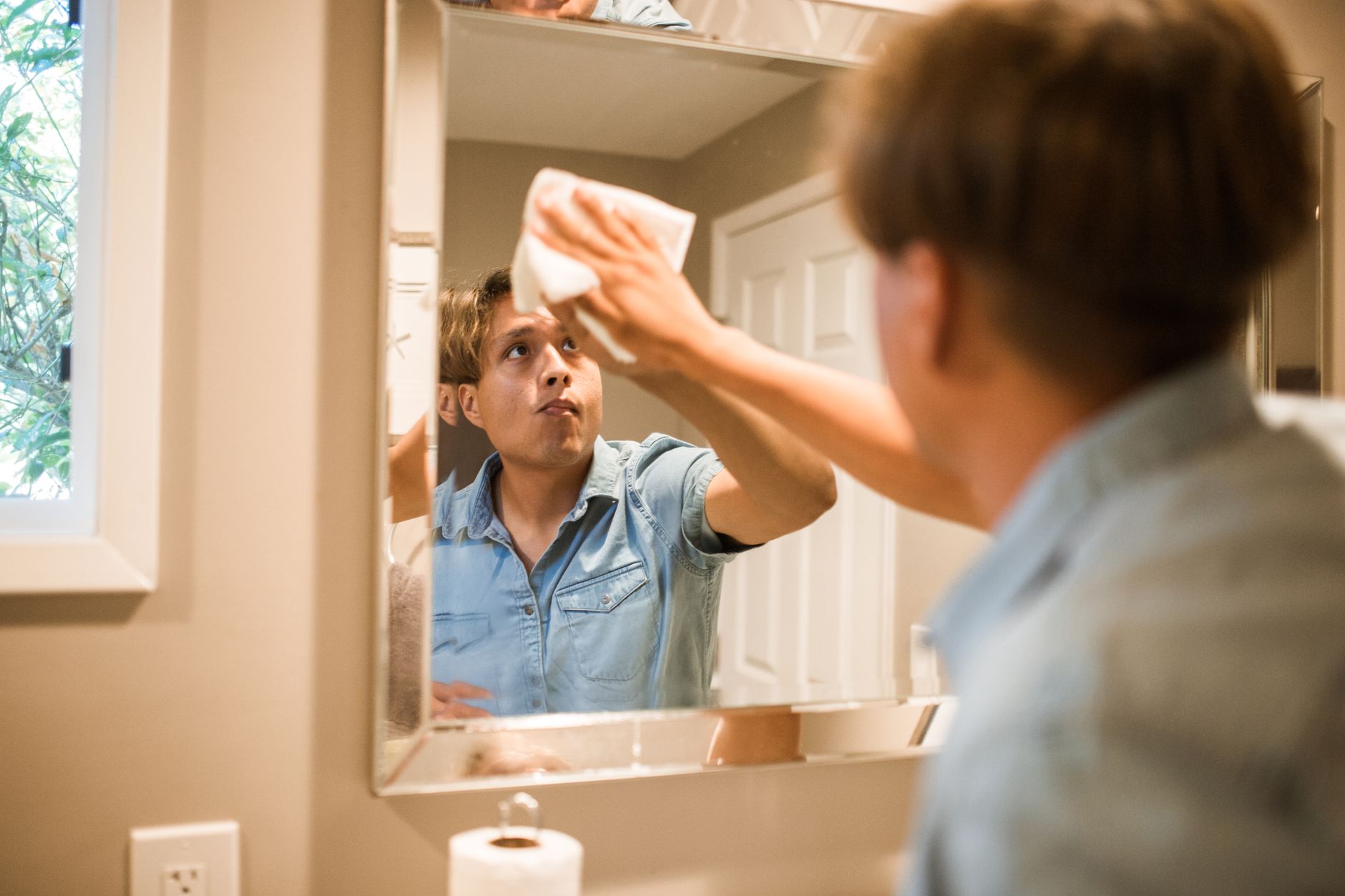 Cleaning a bathroom mirror