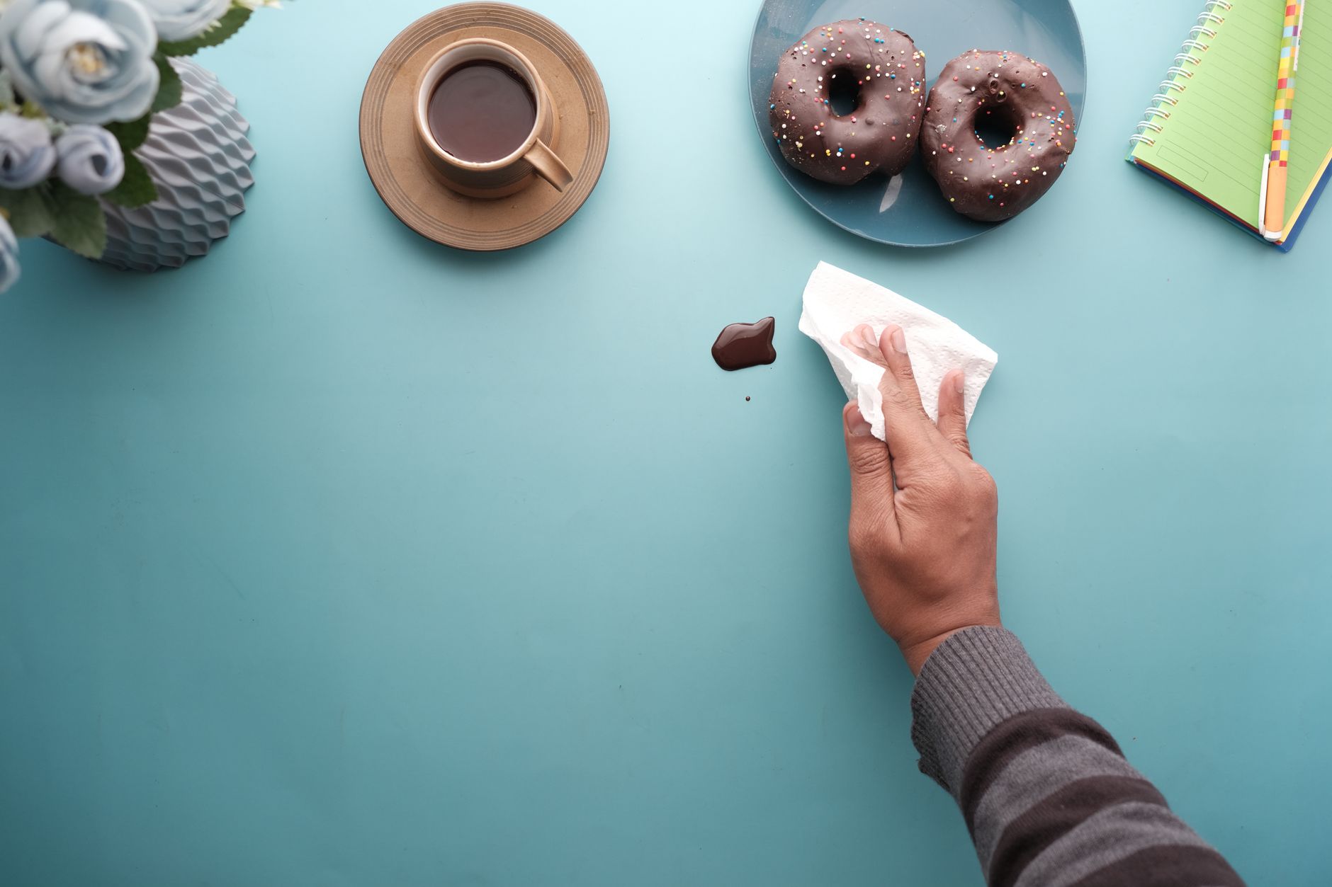 Wiping a spill on a blue table