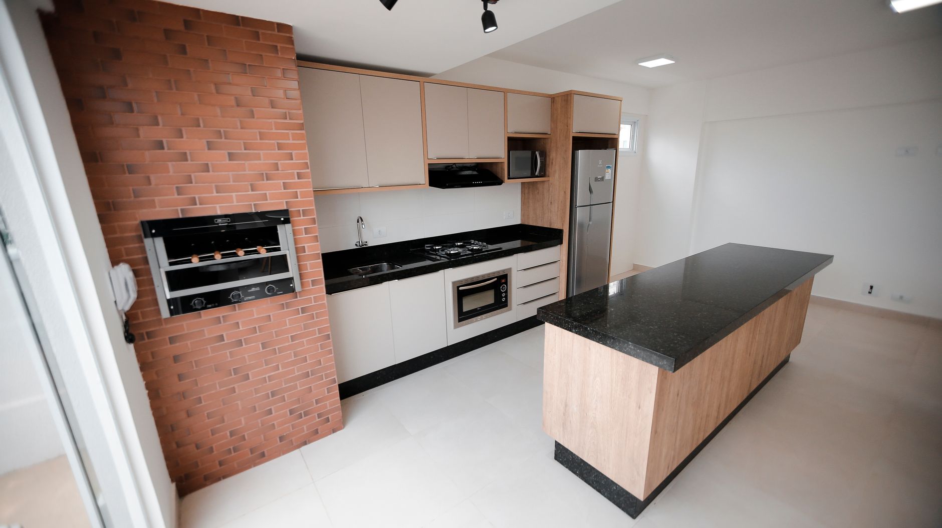 A kitchen with an island and stainless appliances