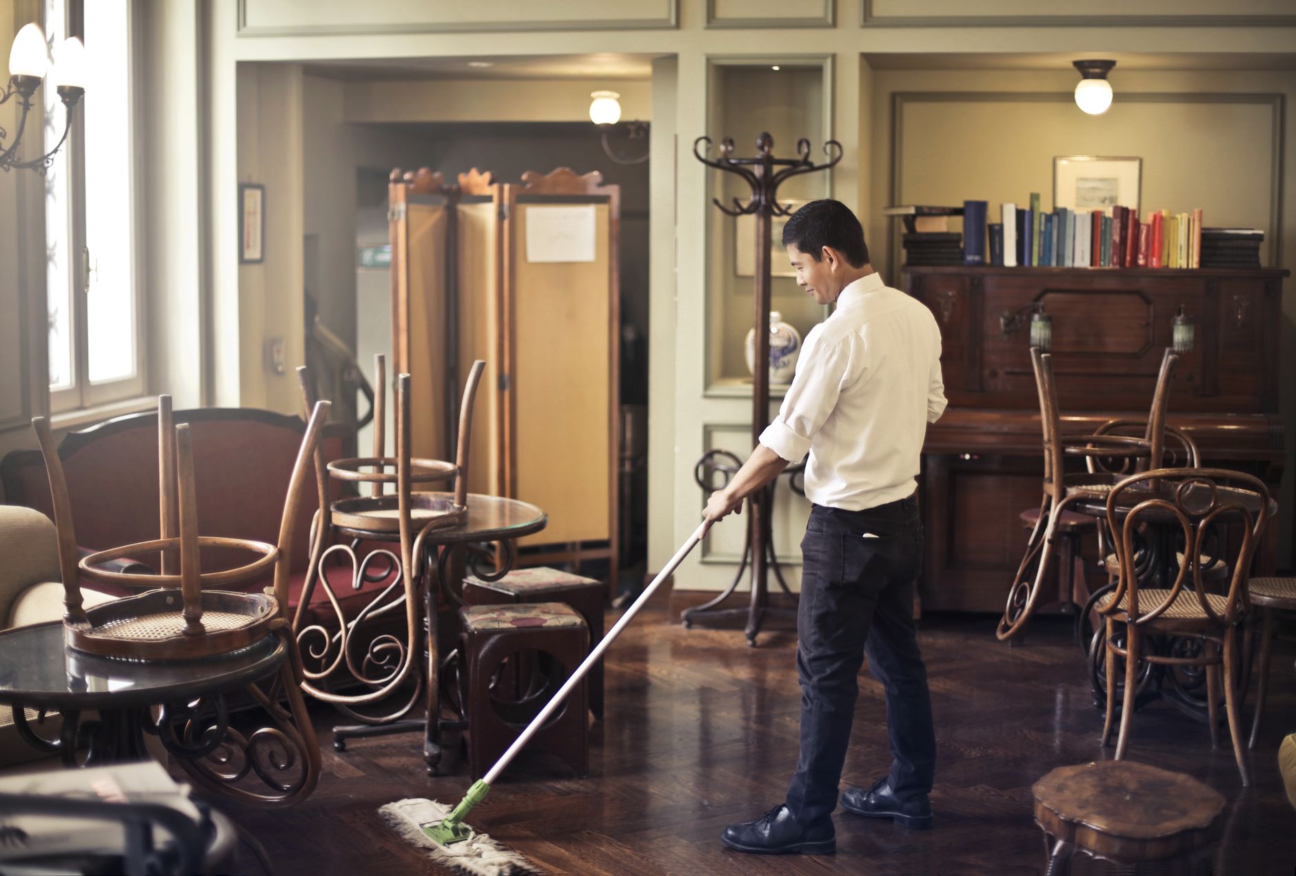 Mopping a cafe floor