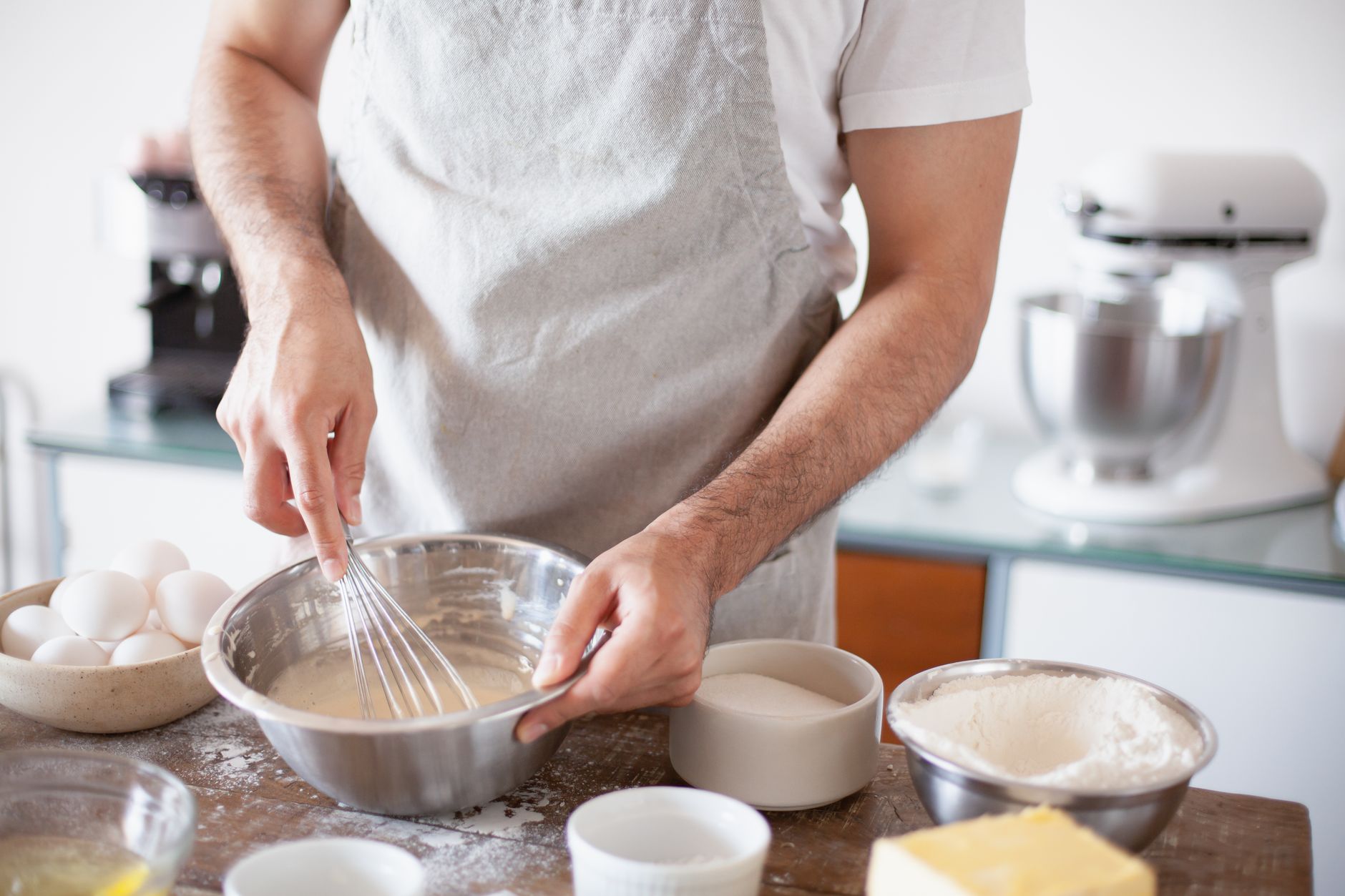 Whisking batter in a stainless steel bowl