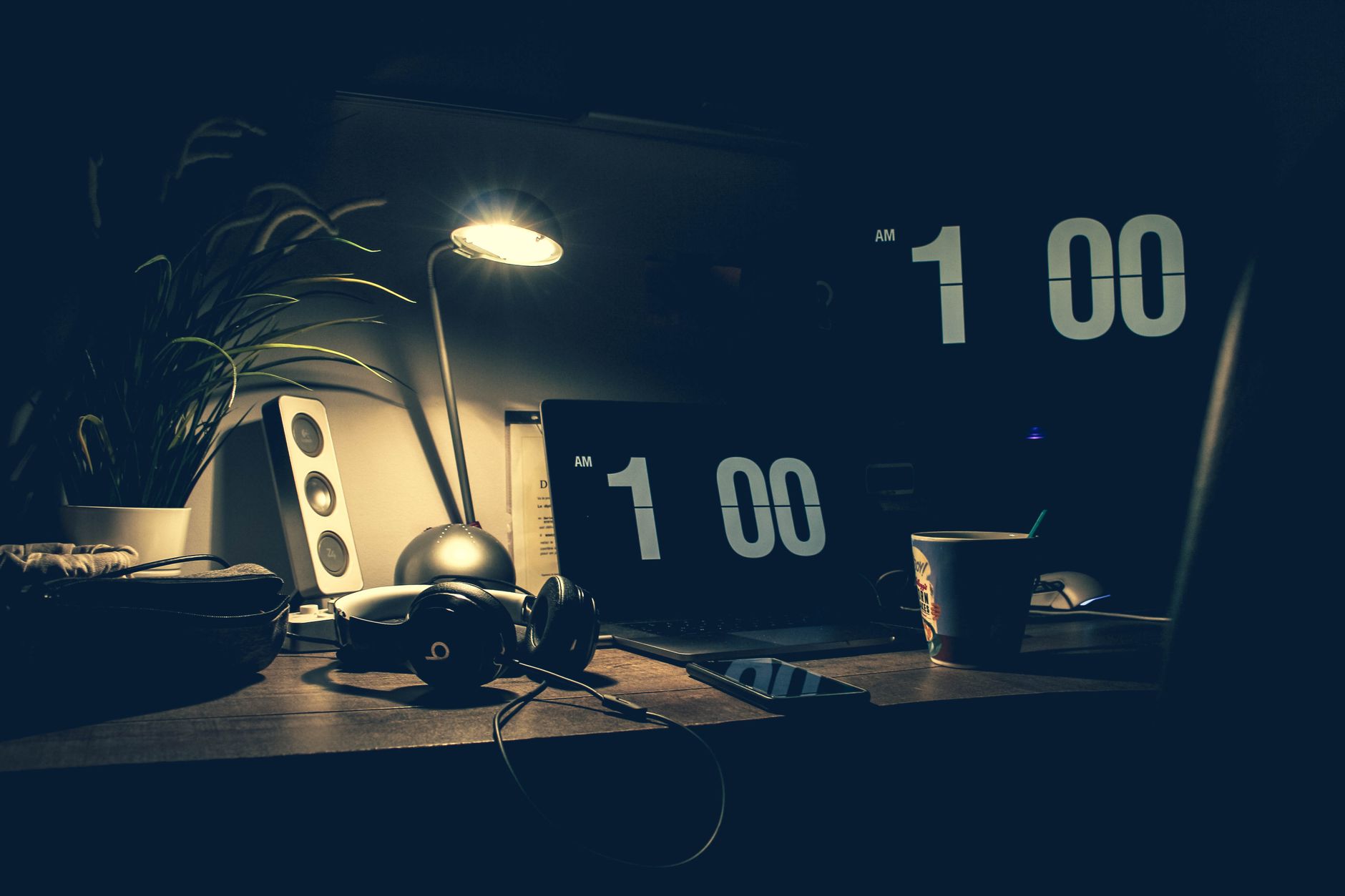 A desk lit for work in the evening