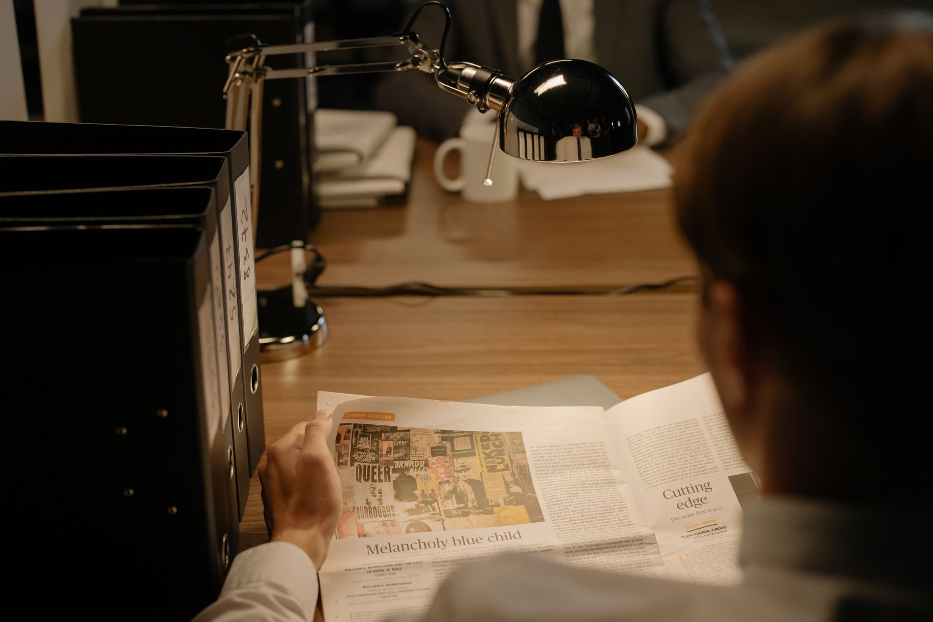 Reading papers at a desk under task lighting