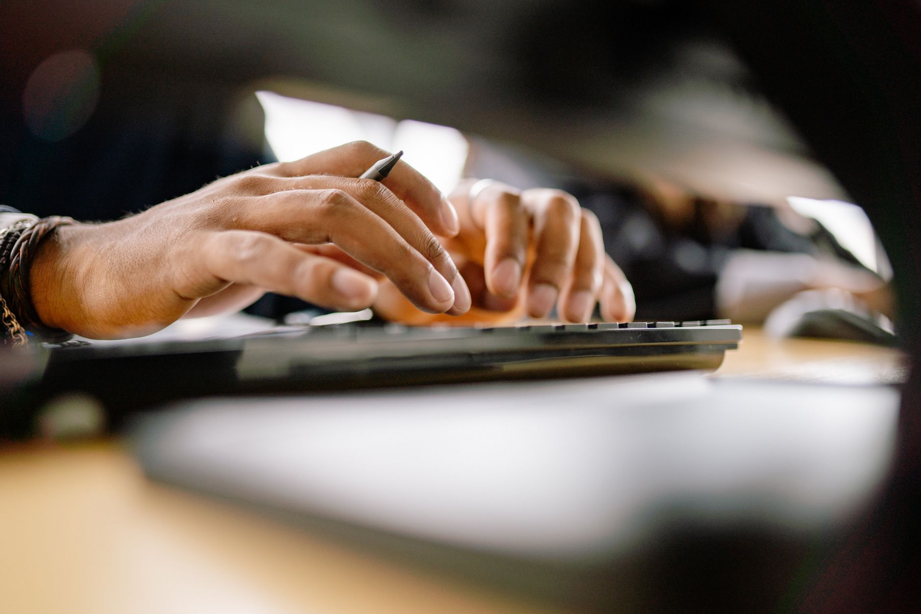 Hands typing on a keyboard