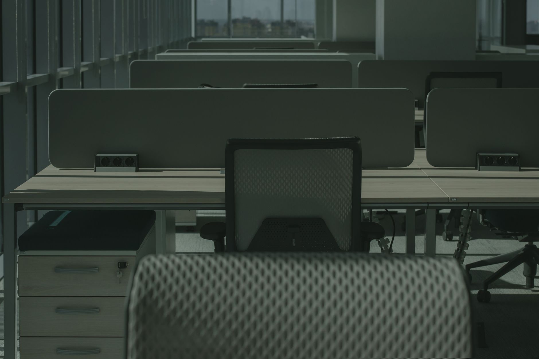 Empty office desks with mesh chairs