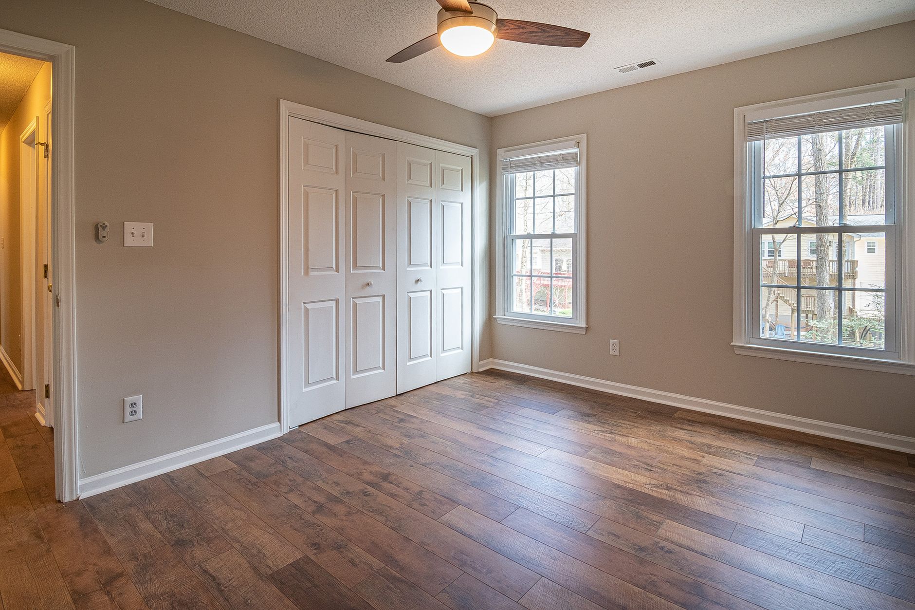 An empty room with wood flooring